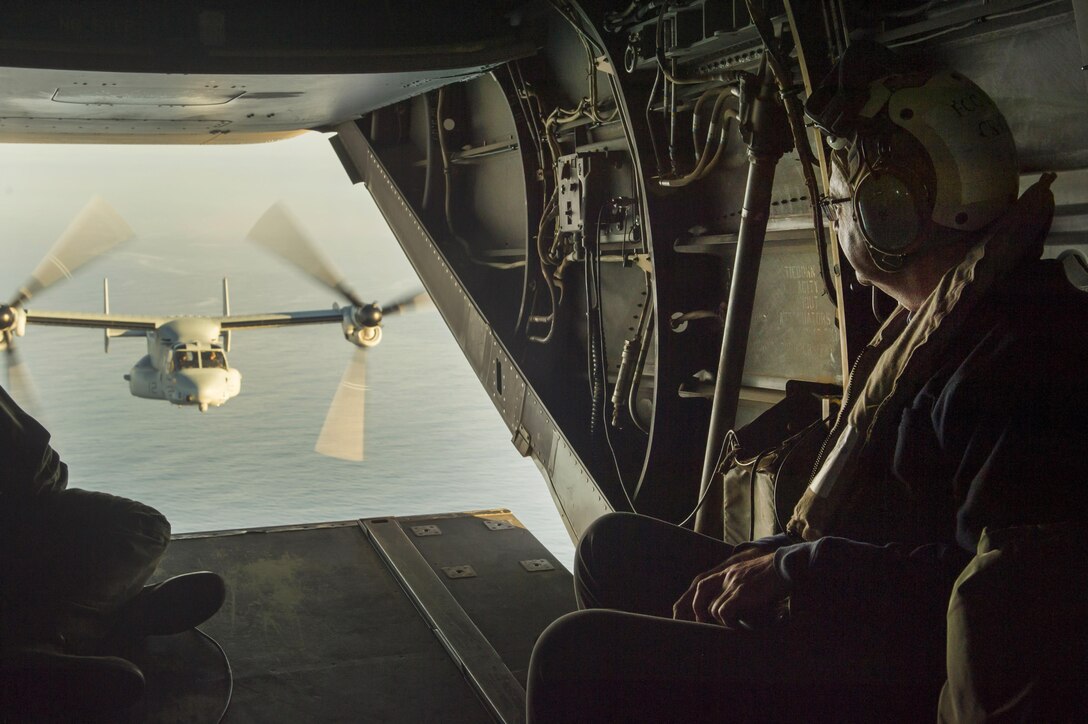 U.S. Defense Secretary Ash Carter watches as an MV-22 Osprey flies in the background while he and Indian Defense Minister Manohar Parrikar depart the USS Dwight D. Eisenhower in the Atlantic Ocean, Dec. 10, 2015. DoD photo by Air Force Senior Master Sgt. Adrian Cadiz