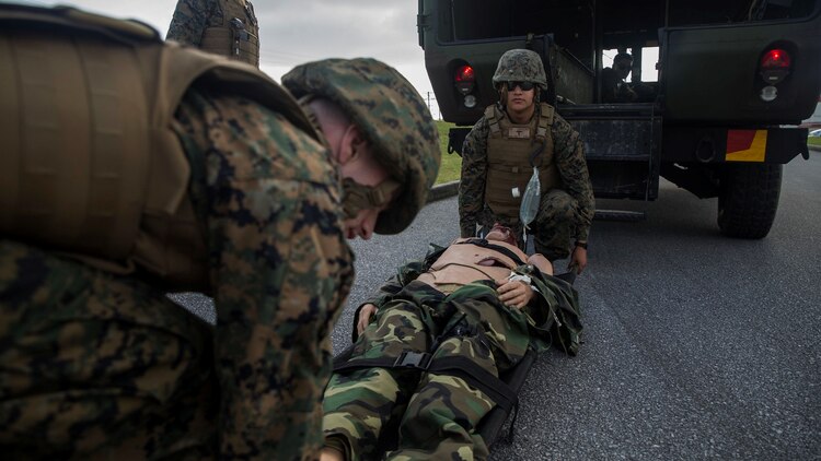 Hospital corpsmen lift a simulated casualty into M997 ambulance during a casualty evacuation drill at Marine Corps Air Station Futenma, Okinawa, Japan Dec. 8, 2015. The casevac course is two weeks long and gives the students a better understanding of what it means to be a corpsman. The corpsmen are with various units with III Marine Expeditionary Force.