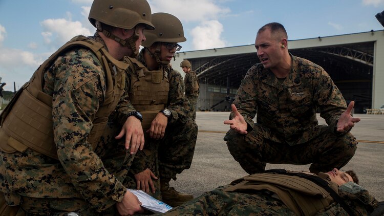 Petty Officer 1st Class Zachary Silveus, right, evaluates students after a casualty evacuation drill at Marine Corps Air Station Futenma, Okinawa, Japan Dec. 8, 2015. The casevac course is two weeks long and gives the students a better understanding of what it means to be a corpsman. The corpsmen are with various units with III Marine Expeditionary Force.