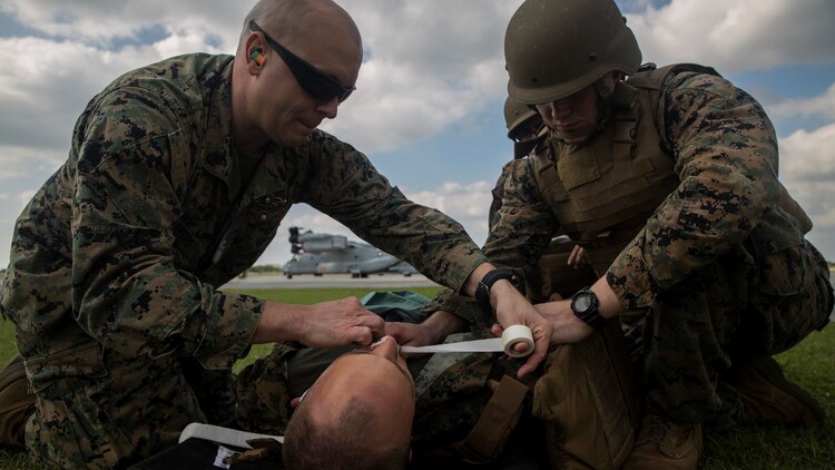 Chief Johnathan Akers, left, helps Seaman Colin Mckeen, right, assess a simulated patient during a casualty evacuation drill at Marine Corps Air Station Futenma, Okinawa, Japan Dec. 8, 2015. The casevac course is two weeks long and gives the students a better understanding of what it means to be a corpsman. The corpsmen are with various units with III Marine Expeditionary Force.