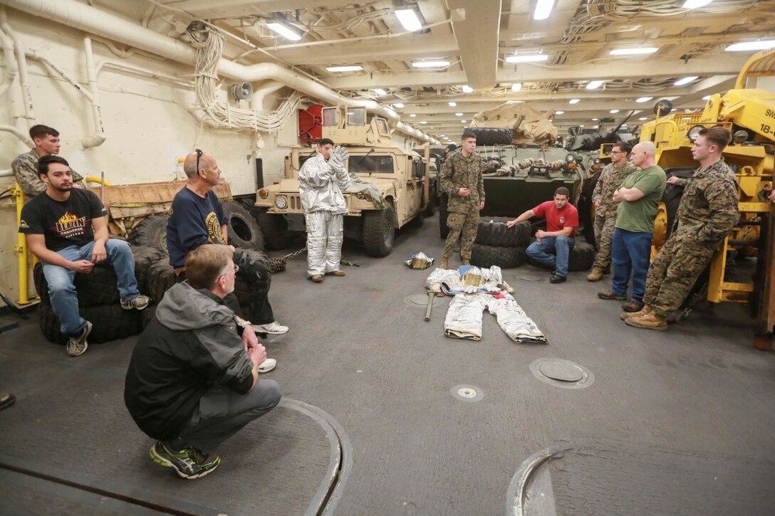 PACIFIC OCEAN (Dec. 9, 2015) U.S. Marine Cpl. Francisco Vargas speaks to the families about the fire suppression system (FSS) aboard the USS Anchorage (LPD 23). Vargas is a bulk fuel specialist with Combat Logistic Battalion 15, 15th Marine Expeditionary Unit. The 15th MEU is coming to the end of deployment and hosting a Tiger Cruise for family members to showcase life aboard the Anchorage. (U.S. Marine Corps photo by Sgt. Steve H. Lopez/Released)