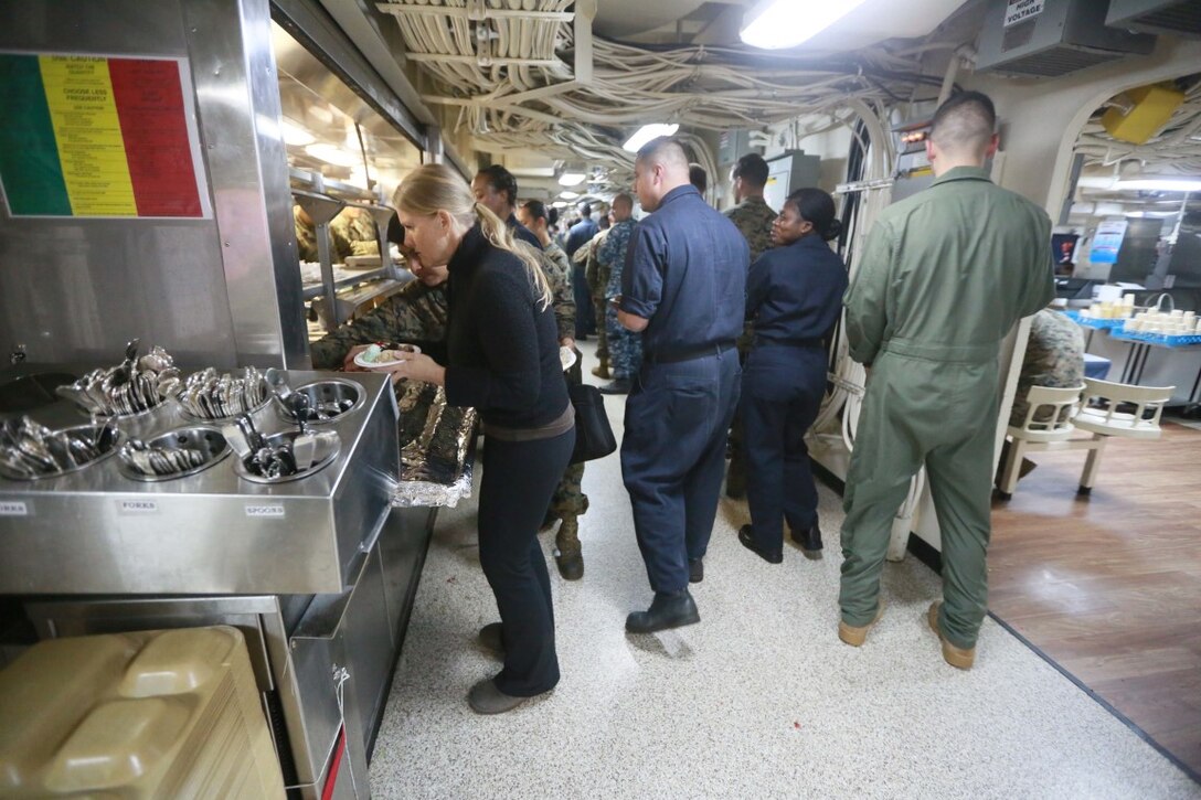 PACIFIC OCEAN (Dec. 9, 2015) U.S. Marines with the 15th Marine Expeditionary Unit and family enjoy an ice cream social aboard the USS Anchorage (LPD 23). The 15th MEU is coming to the end of deployment and hosting a Tiger Cruise for family members to showcase life aboard the Anchorage. (U.S. Marine Corps photo by Sgt. Steve H. Lopez/Released)