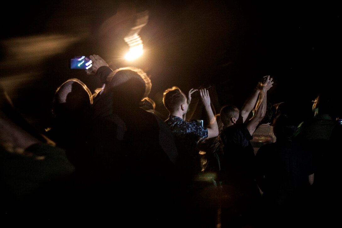PACIFIC OCEAN (Dec. 9, 2015) - U.S. Marines with the 15th Marine Expeditionary Unit and Sailors with the Essex Amphibious Ready Group watch a 'fireworks' weapons display with the family members on the flight deck of amphibious assault ship USS Essex (LHD 2). The family members are on a Tiger Cruise from Hawaii back to California to experience the day-to-day life of their Marines and Sailors. (U.S. Marine Corps photo by Sgt. Elize McKelvey/Released)