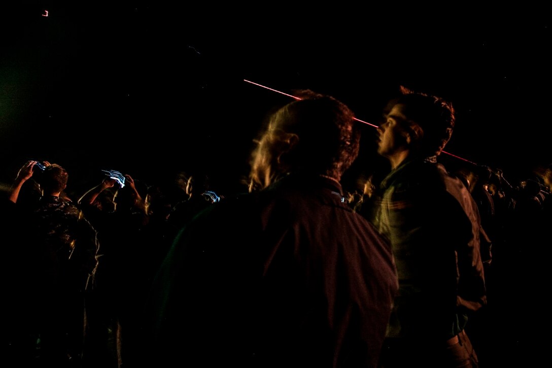 PACIFIC OCEAN (Dec. 9, 2015) - U.S. Marines with the 15th Marine Expeditionary Unit and Sailors with the Essex Amphibious Ready Group watch a 'fireworks' weapons display with the family members on the flight deck of amphibious assault ship USS Essex (LHD 2). The family members are on a Tiger Cruise from Hawaii back to California to experience the day-to-day life of their Marines and Sailors. (U.S. Marine Corps photo by Sgt. Elize McKelvey/Released)