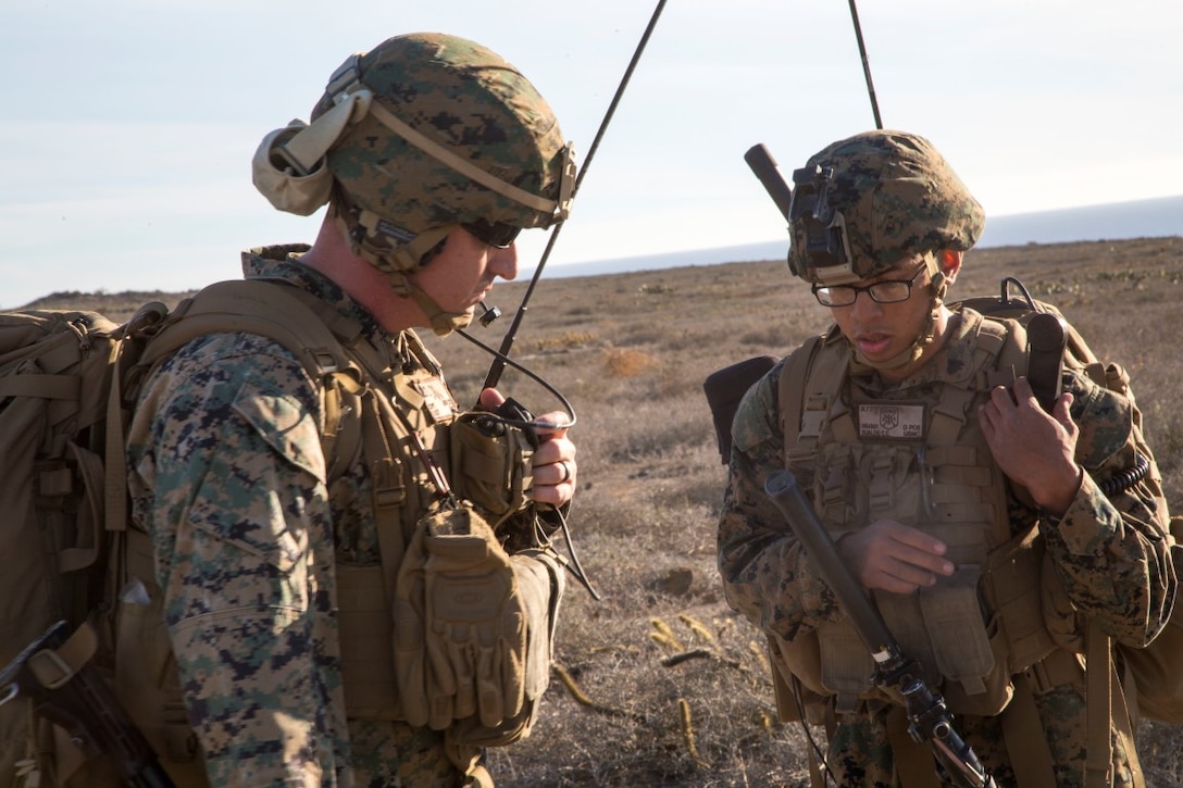 U.S. Marine Capt. Shannon Ashley and Cpl. Colin Sualog with Battalion Landing Team 2/1, 13th Marine Expeditionary Unit (MEU), check communication networks during a simulated mission to secure an airfield, local village and provide aid to refugees during Certificate Exercise (CERTEX) at San Clemente Island, California, Dec. 6, 2015. CERTEX is the final evaluation period of the 13th MEU and Boxer Amphibious Ready Group prior to deployment and is intended to certify their readiness to conduct integrated missions across the full spectrum of military operations. (U.S. Marine Corps photo by Cpl. Briauna Birl/RELEASED)