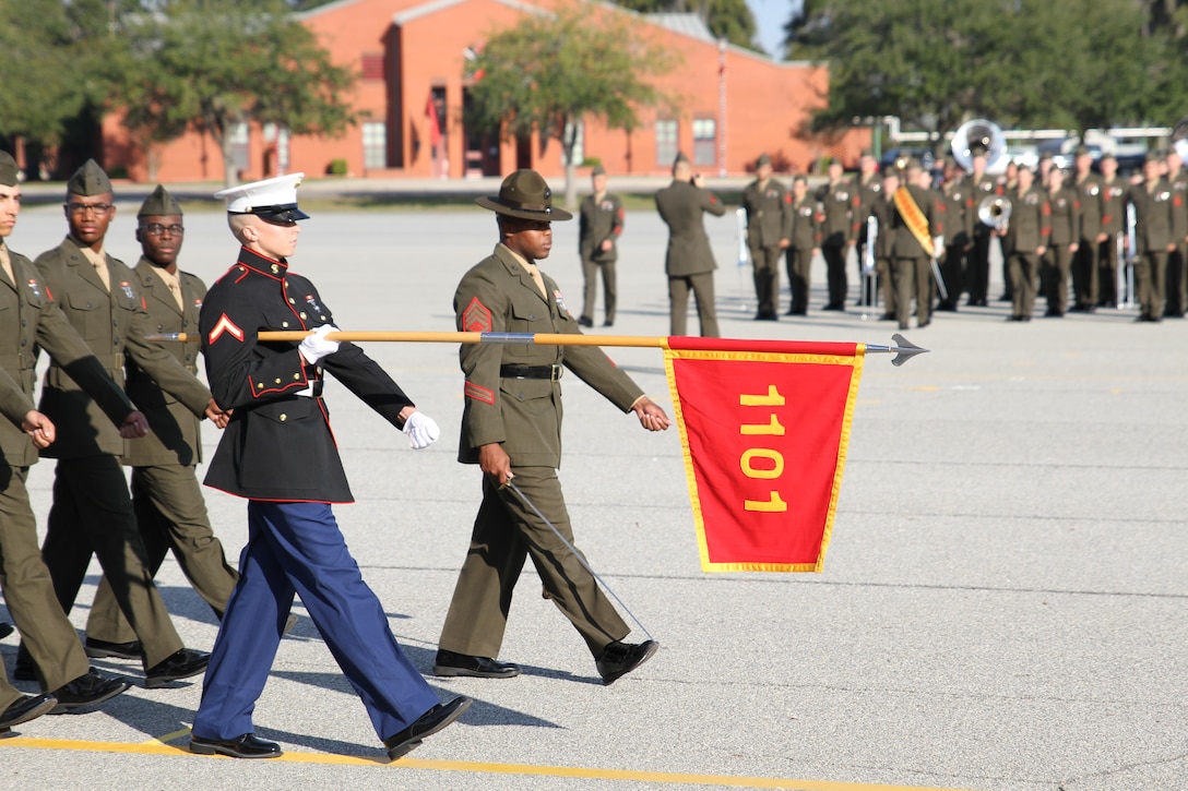 Honor graduate of platoon 1101, Pfc. James T. Montgomery, marches across the parade deck with his platoon during the pass and review Dec. 11, 2015, Marine Corps Recruit Depot Parris Island, S.C. Montgomery, a native of Brandon, Fla., was recruited by Gunnery Sgt. Salgado at Recruiting Station Orlando. (Official Marine Corps photo by Cpl. Diamond N. Peden/Released)