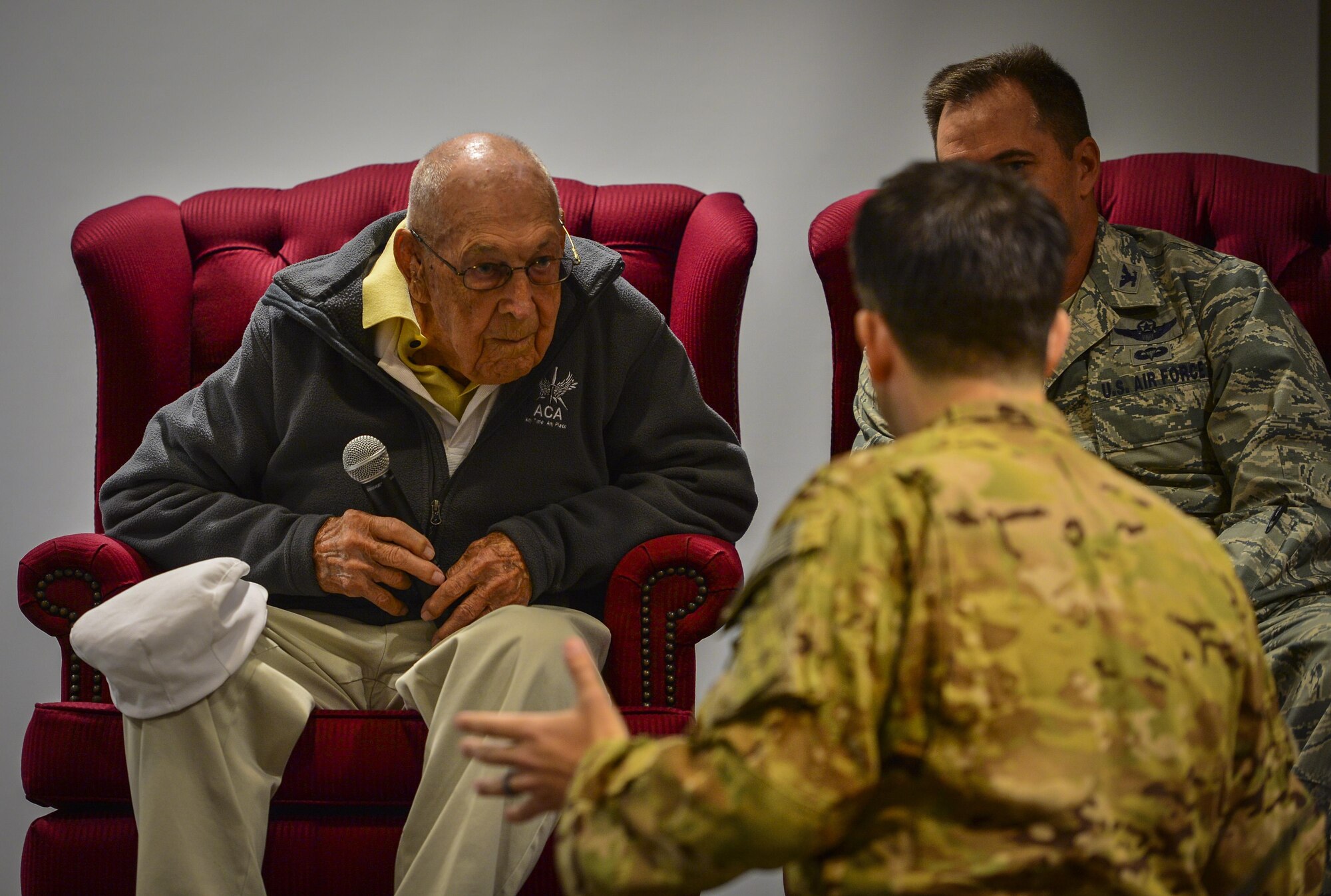 Capt. Daniel Jackson, a pilot with the 319th Special Operations Squadron, talks to retired Lt. Col. Richard E. Cole, a Doolittle Raider, during a question and answer session at the 319th Special Operations Squadron, Hurlburt Field, Fla., Dec. 9, 2015. Air Commandos asked Cole various questions about his experiences during his time in service and as a member of the Doolittle Raid on April 18, 1942. (U.S. Air Force photo by Staff Sgt. Marleah Robertson)
