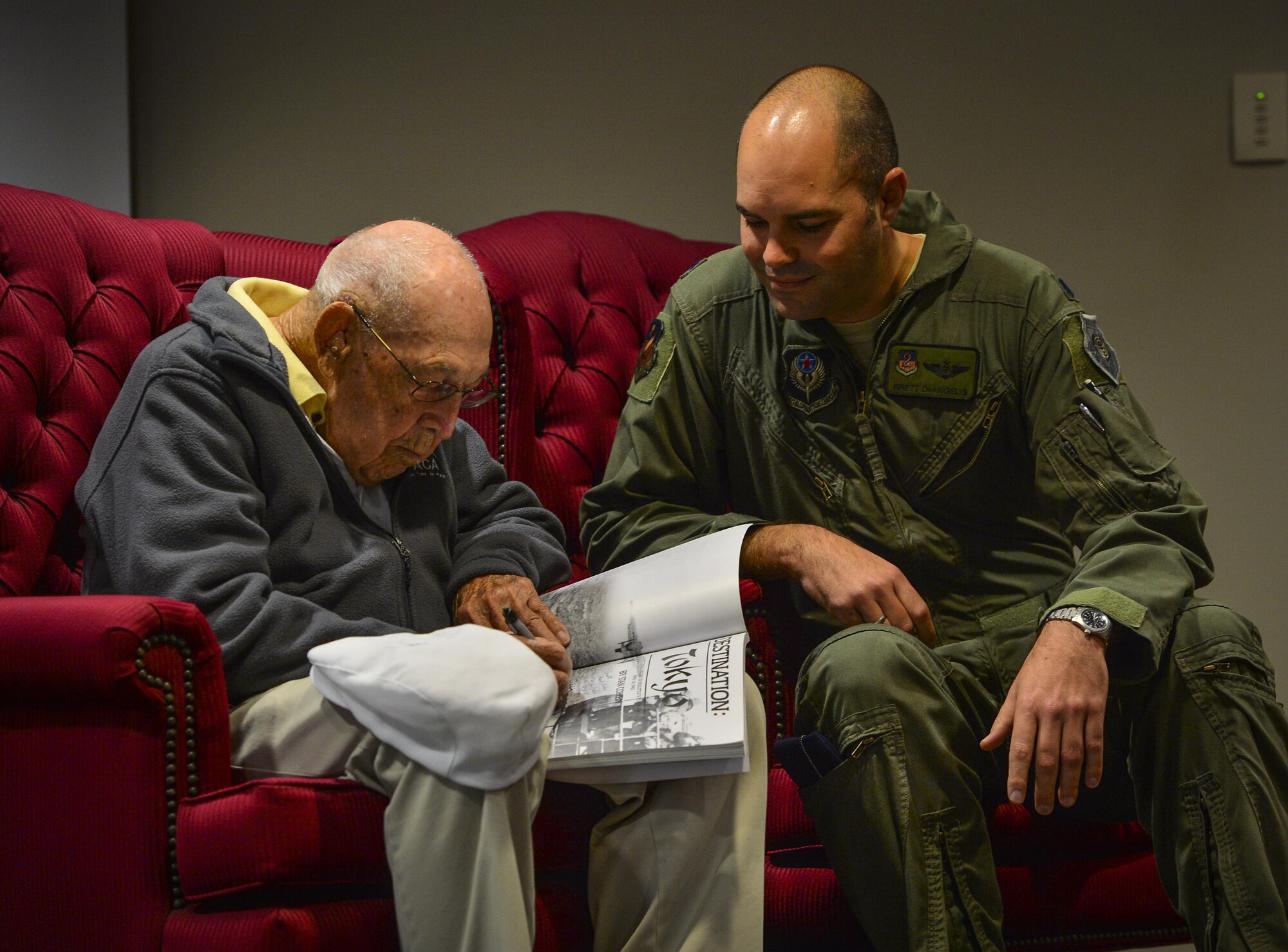 Retired Lt. Col. Richard E. Cole, left, a Doolittle Raider, signs a book for Lt. Col. Brett DeAngelis, commander of the 1st Special Operations Group Detachment 2, after a question and answer session at the 319th Special Operations Squadron, Hurlburt Field, Fla., Dec. 9, 2015. Cole left the current and future generations of Air Commandos at the 319th SOS with some final advice, “Always keep learning – learn everything you can about everything and charge on.” (U.S. Air Force photo by Staff Sgt. Marleah Robertson)
