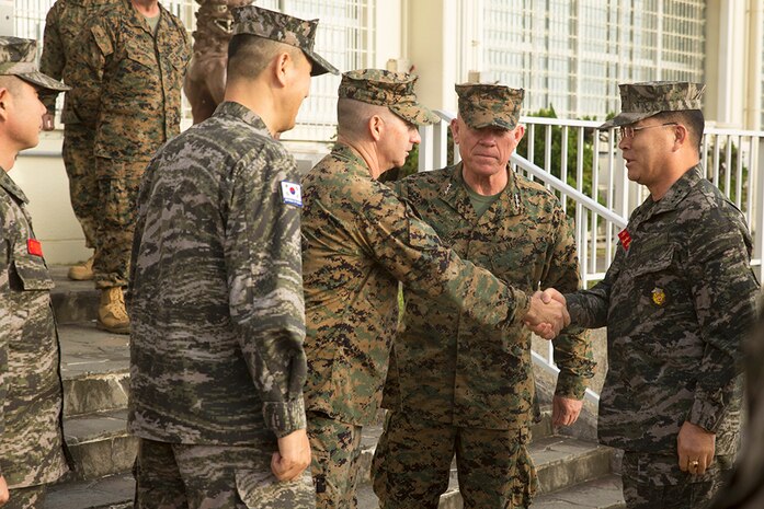 Lt. Gen. Sang Hoon Lee, commandant of the of the Republic of Korea Marine Corps, right, greets Col. Erik B. Kraft, III Marine Expeditionary Force operations officer, left, before entering III MEF Headquarters to talk about strengthening plans, operations and relationships between the two militaries Dec. 11, at Camp Courtney. Lee was on Okinawa from Dec. 11 to increase awareness of senior leader collaboration and oneness of the Combined Marine Component Command. The CMCC is a focused combined force designed to protect the safety and security of the people of Korea. 