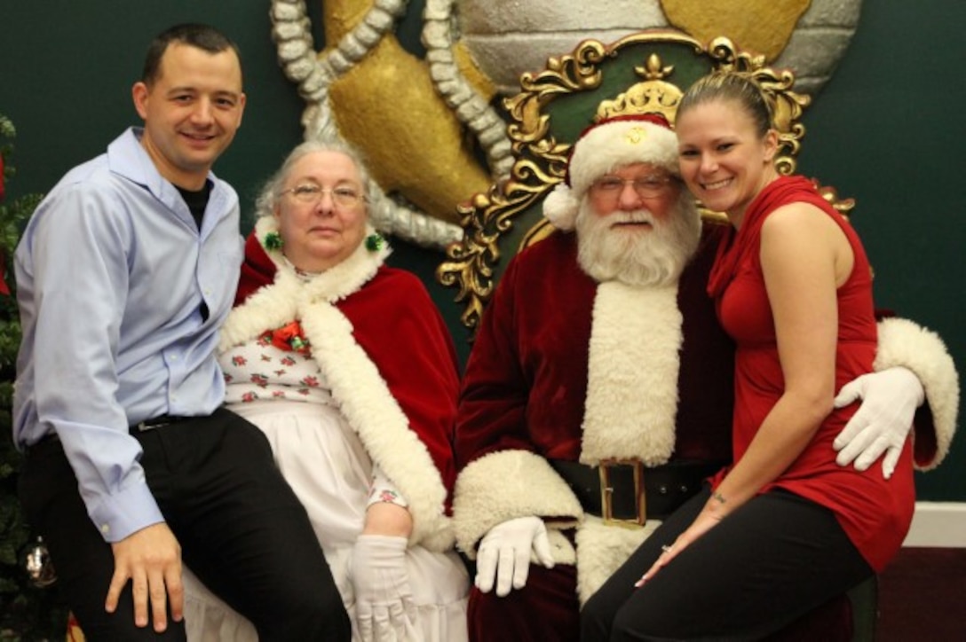 Staff Sgt. Richard Weiss and his wife, Staff Sgt. Kimberly Weiss pose with Santa Claus during a Christmas Party Dec. 8, 2015 at Traditions on Parris Island, S.C. 6th Marine Corps District holds an annual Christmas party to celebrate the holidays with the Marines and their families to boost morale and camaraderie among one another.(Official Marine Corps photo by Cpl. Diamond N. Peden/Released)