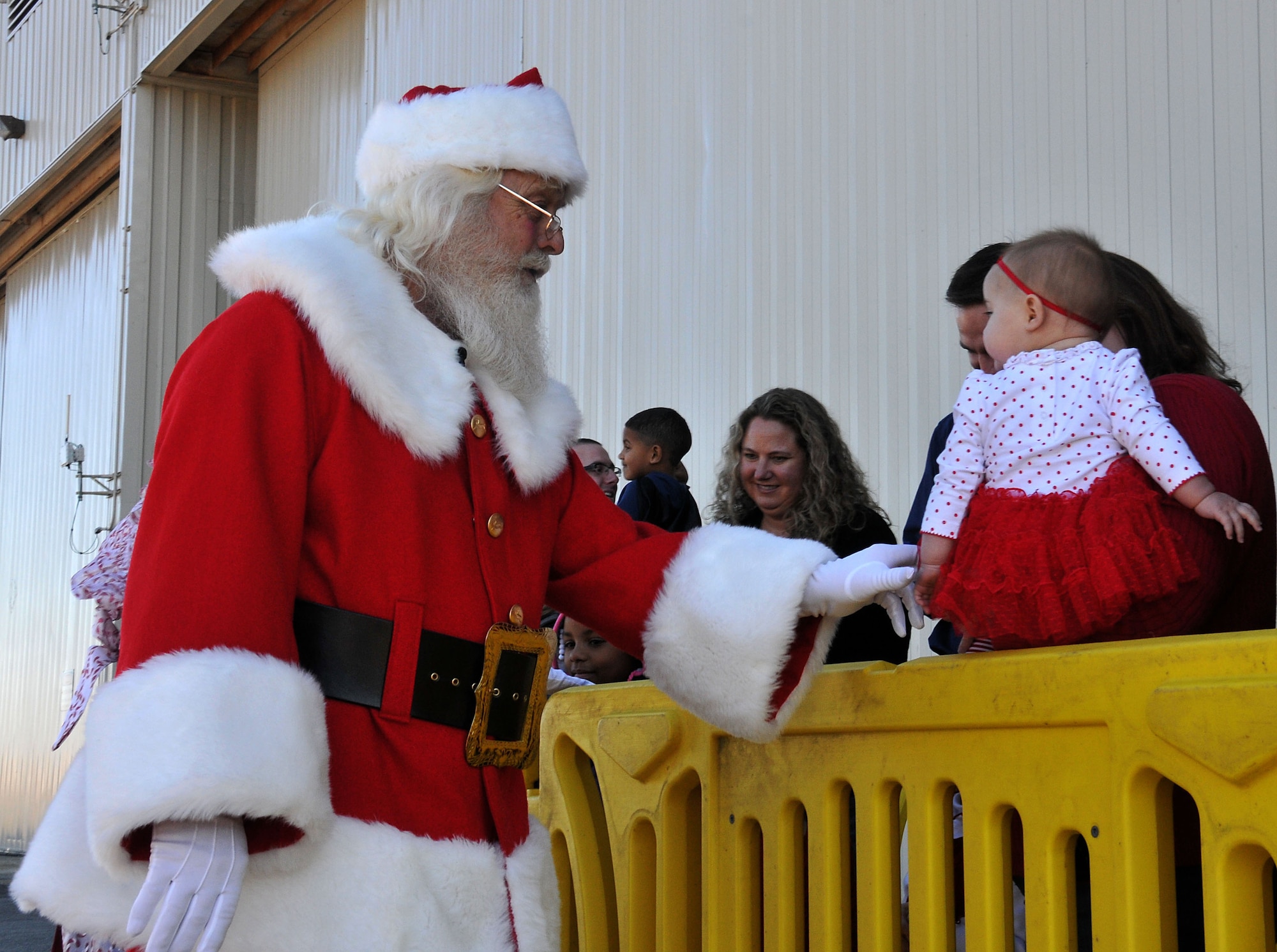 Santa Claus greets a young devotee outside Hangar 5 at Dobbins Air Reserve Base, Ga. on Dec. 5, 2015. Claus took time to shake hands and take pictures with family members waiting for him to arrive via a C-130 Hercules. (U.S. Air Force photo/Senior Airman Andrew Park)