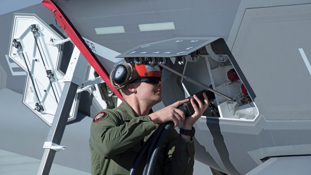 Cpl. Luke Somers links a power cord to an F-35B Lightning II aircraft in preparation for a weapons functional test during Exercise Steel Knight at Marine Corps Air Ground Combat Center Twentynine Palms, California, Dec. 10, 2015. Somers is an ordinance technician with Marine Operational and Test Evaluation Squadron 22. The F-35B is a single seat, single engine stealth multi-role fighter bringing the Marine Corps into a whole new generation of aircraft. Exercise Steel Knight allowed for Marine Fighter Attack Squadron 121 and VMX-22 to train on integrating the F-35B and find its place in the Marine Air Ground Task Force, while giving the ground forces of 1st Marine Division the ability to become familiar with it.