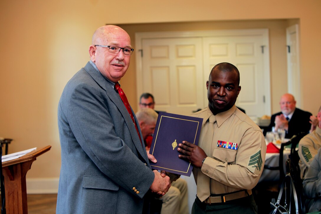 Sgt. Shawn H. Rose accepts a certificate of appreciation from George S. Liner to honor Rose for becoming the New Bern Military Alliance and Chamber of Commerce Service Person of the Quarter, Dec. 10, 2015, at the New Bern Country Club in New Bern, N.C. Rose arrived at the air station in June and was promptly assigned as the unit’s Single Marine Program representative, which has given him several opportunities to contribute to the community. Rose is an aircraft electrical systems technician with Marine Attack Squadron 542, and Liner is a Craven County Commissioner. (U.S. Marine Corps photo by Pfc. Nicholas P. Baird/Released)