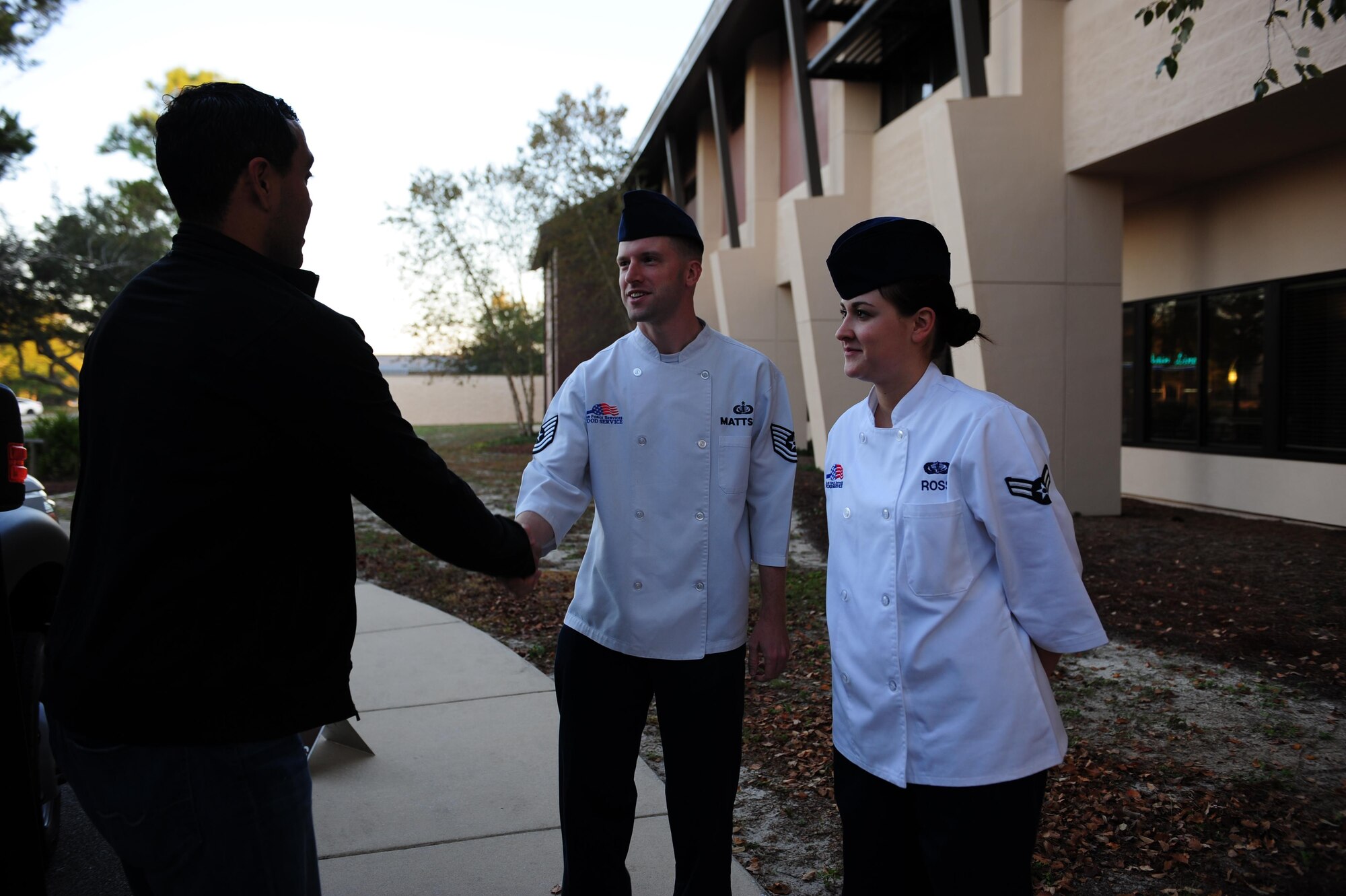 Jairek Robbins, a performance coach, meets Tech. Sgt. Timothy Mattson, a dining facility manager with the 1st Special Operations Force Support Squadron and Airman 1st Class Alyssa Ross, a food service specialist with the 1st SOFSS, during his visit to the Riptide dining facility at Hurlburt Field, Fla., Dec. 9, 2015. During the two-day visit, Robbins met with Airmen around Hurlburt Field to better understand Air Force Special Operations Command's mission and gave a motivational presentation to more than 300 Air Commandos at the end of his visit. (U.S. Air Force photo by Senior Airman Meagan Schutter)