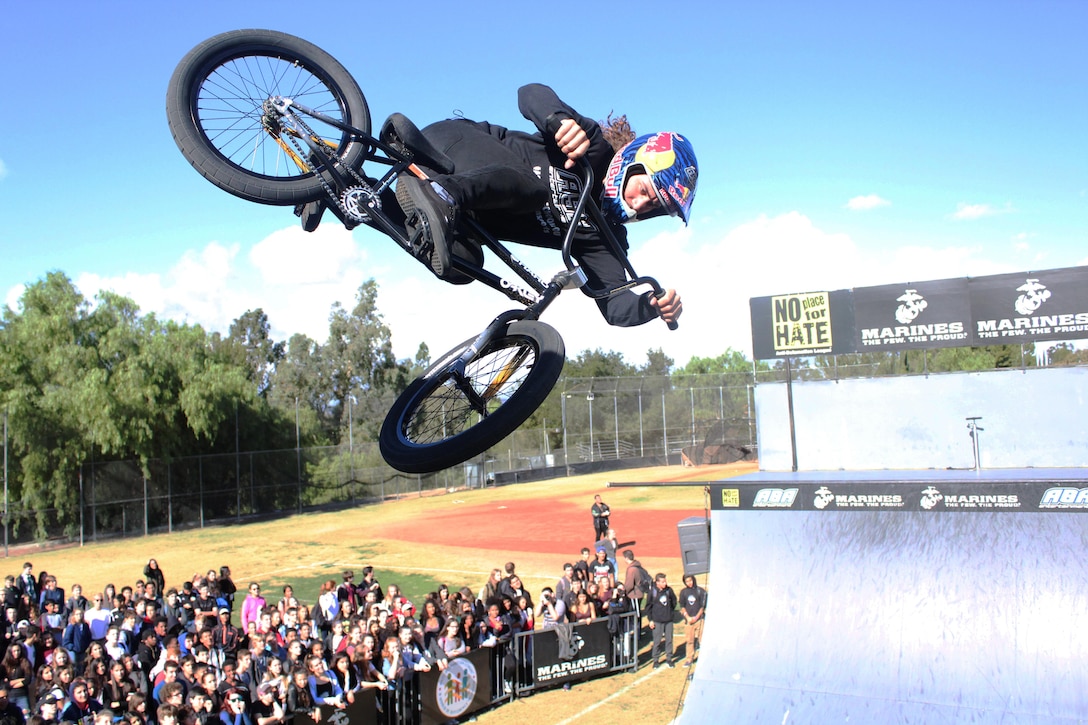 BMX biker Coco Zurita performs a stunt in front of hundreds of students at Calabasas High School during the 2015 ASA High School Tour, Dec. 11. The tour is an interactive “extreme” sports show that visits high schools throughout the United States with several of the world’s top professional skateboarders, BMX bikers and inline skaters delivering an anti-bullying and anti-tobacco message. Recruiters from Recruiting Sub Station Granada Hills also attended the event and held a pull-up and flexed-arm hang challenge. (U.S. Marine Corps photo by Staff Sgt. Alicia R. Leaders/Released)