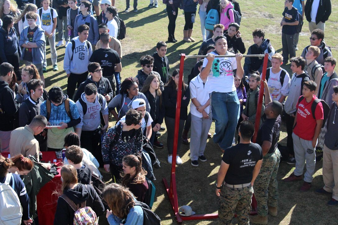 A Calabasas High School student performs the pull-up challenge during the 2015 ASA High School Tour, Dec. 11. Some of the world’s top professional skateboarders, inline skaters and BMX bikers perform on a state-of-the-art pro half-pipe, while an emcee delivers an anti-bullying and anti-tobacco message during an ASA High School Tour. Recruiters from Recruiting Sub Station Granada Hills also attended the event and held a pull-up and flexed-arm hang challenge. (U.S. Marine Corps photo by Staff Sgt. Alicia R. Leaders/Released)  