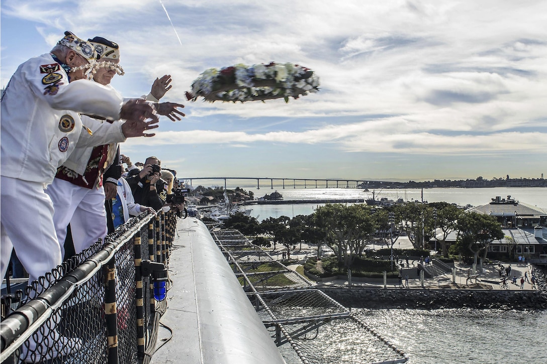 Stu Hedley and Jack Evans, both Pearl Harbor survivors, toss a wreath into the San Diego Bay to honor those who lost their lives in the Pearl Harbor attacks during a Pearl Harbor remembrance ceremony aboard the USS Midway Museum in San Diego, Dec. 7, 2015. U.S. Navy photo by Petty Officer 3rd Class Gerald Dudley Reynolds 