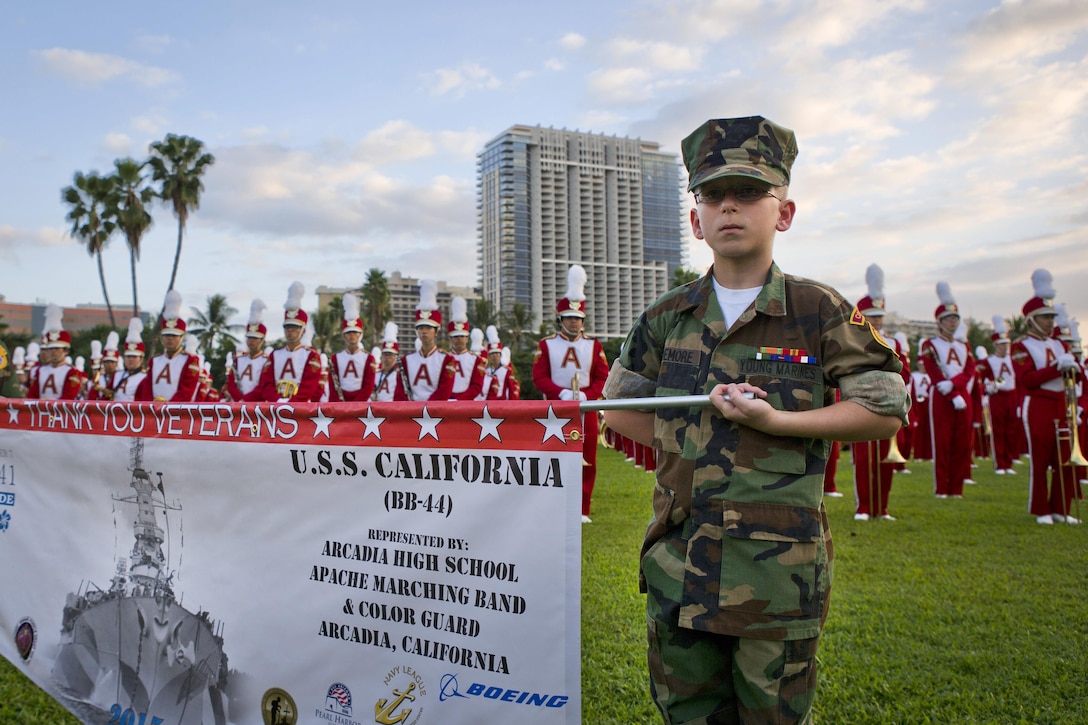 Raven Pridemore, a private in the Young Marines, carries a banner during the opening ceremony of the Pearl Harbor Memorial Parade on Fort DeRussy Park in Honolulu, Dec. 7, 2015. U.S. Marine Corps photo by Lance Cpl. Miguel Rosales