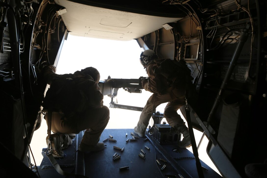 A U.S. Marine crew chief with Marine Medium Tiltrotor Squadron 268, Special Purpose Marine Air Ground Task Force-Crisis Response-Central Command, fires an M2A2 .50 caliber machine gun from the tail of an MV-22B Osprey during a live-fire training mission at an undisclosed location in Southwest Asia, Dec. 8, 2015. VMM-268 is capable of conducting assault operations as part of SPMAGTF-CR-CC’s crisis response mission spanning 20 nations in the U.S. Central Command area of responsibility.