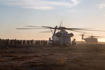 U.S. Marines with Battalion Landing Team 2/1, 13th Marine Expeditionary Unit (MEU), load U.S. Marine Corps CH-53 helicopters after completion of a mission to secure an airfield, local village and provide aid to refugees during Certificate Exercise (CERTEX) at San Clemente Island, California, Dec. 7, 2015. CERTEX is the final evaluation period of the 13th MEU and Boxer Amphibious Ready Group prior to deployment and is intended to certify their readiness to conduct integrated missions across the full spectrum of military operations. (U.S. Marine Corps photo by Cpl. Briauna Birl/RELEASED)