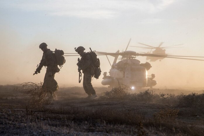 U.S. Marines with Battalion Landing Team 2/1, 13th Marine Expeditionary Unit (MEU), move into position as two U.S. Marine Corps CH-53 helicopters land to extract Marines after completion of a simulated mission to secure an airfield, local village and provide aid to refugees during Certificate Exercise (CERTEX) at San Clemente Island, California, Dec. 7, 2015. CERTEX is the final evaluation period of the 13th MEU and Boxer Amphibious Ready Group prior to deployment and is intended to certify their readiness to conduct integrated missions across the full spectrum of military operations. (U.S. Marine Corps photo by Cpl. Briauna Birl/RELEASED)
