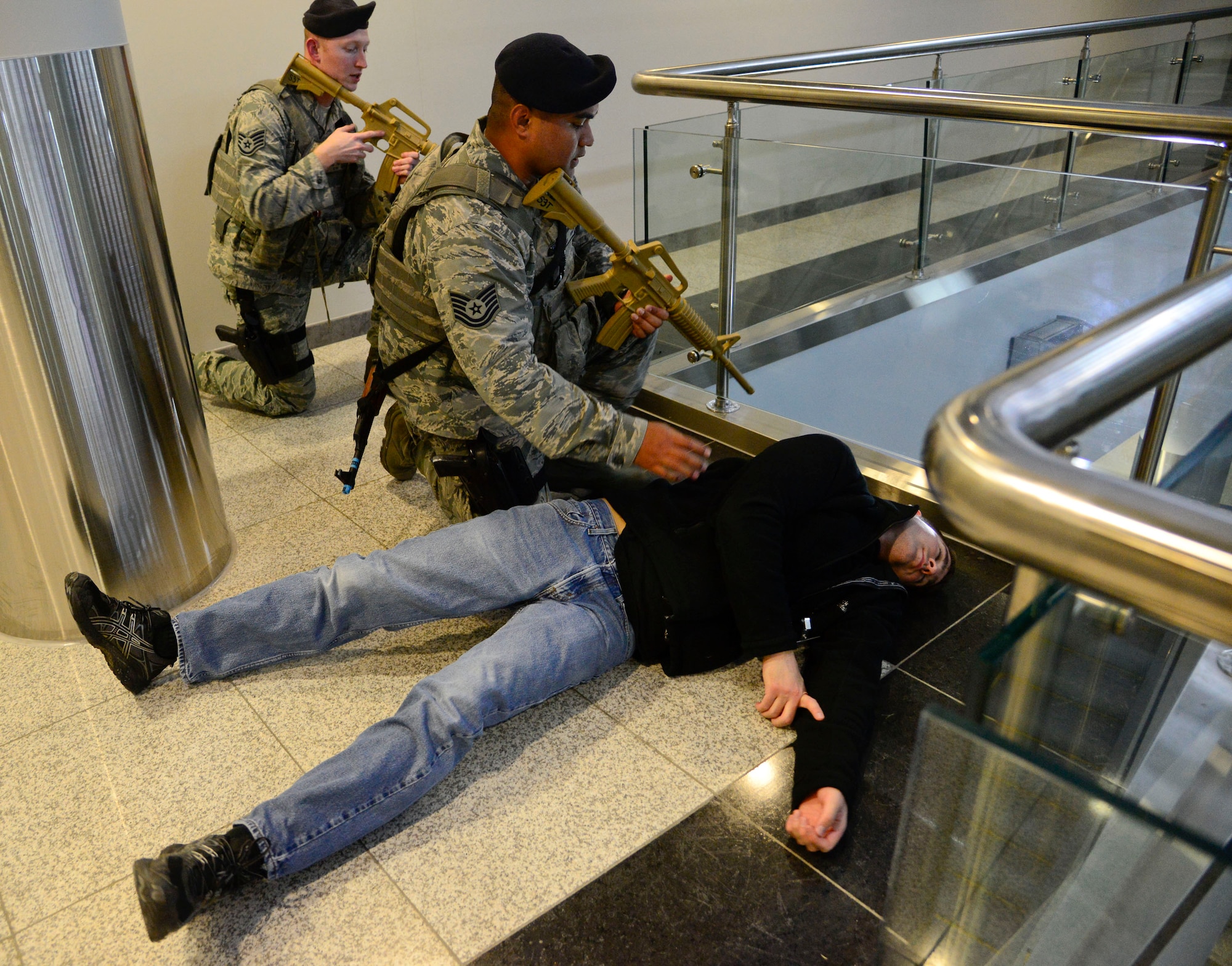 Tech. Sgt. Benjamin Kolise, 51st Security Forces defenders checks a simulated active-shooter for injuries and weapons during an internal exercise on Osan Air Base, Republic of Korea, Dec. 10, 2015. The defenders ensure all possible threats are removed and the active shooter is controlled before declaring an area safe. The active shooter exercises and training allows both the defenders and the squadrons associated to train in the event of a real-world incident. (U.S. Air Force photo/Senior Airman Kristin High)