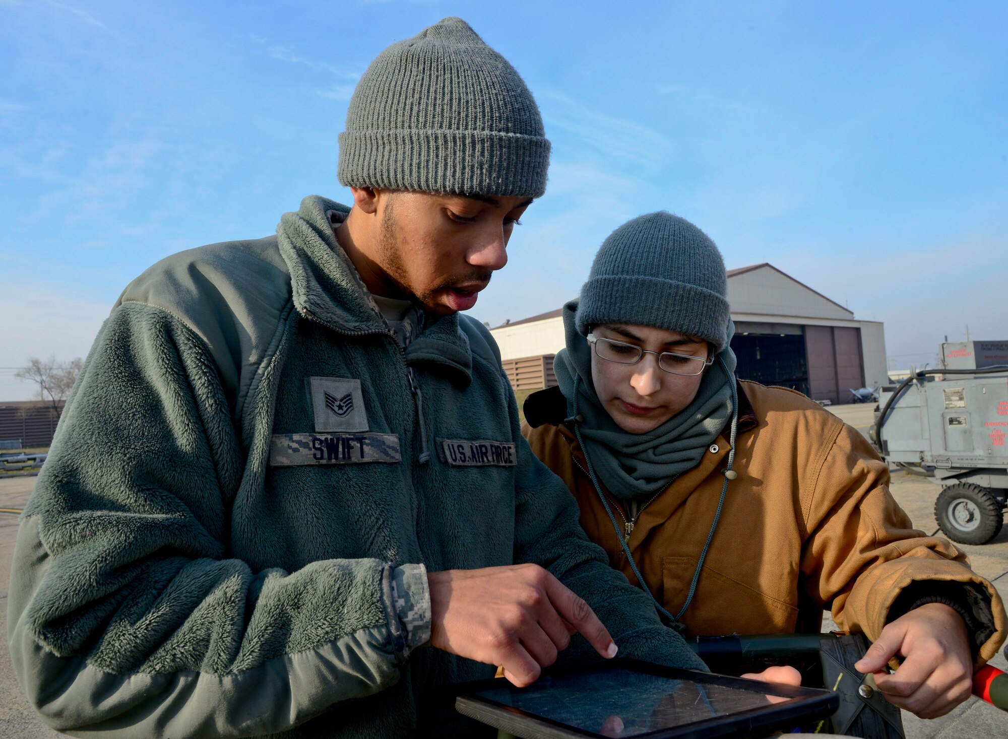 Staff Sgt. Ashton Swift and Senior Airman Sarah Barrera, 51st Maintenance Squadron aircraft fuels systems repair technicians, look over a technical order while working on an F-16 Fighting Falcon on Osan Air Base, Republic of Korea, Dec. 9, 2015. The TOs ensures Airmen perform each step of their job correctly to prevent maintenance errors from occurring. (U.S. Air Force photo/Senior Airman Kristin High)