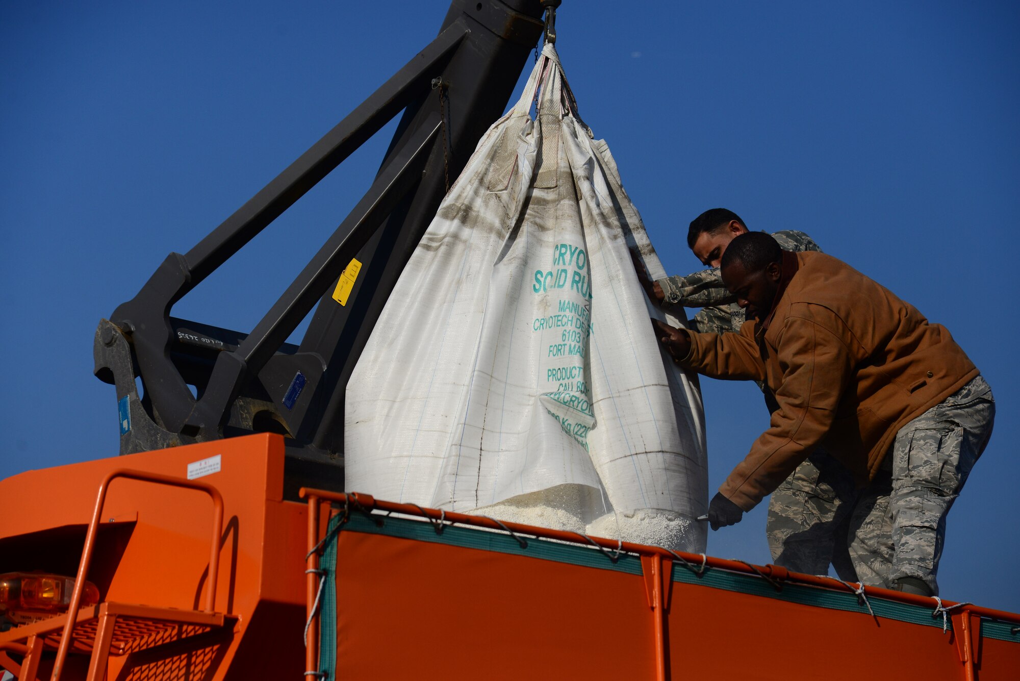 Pavement and construction equipment Airmen from the 51st Civil Engineer Squadron fill the back of a dump truck with deicing chemicals at Osan Air Base, Republic of Korea, Dec. 8, 2015.  When mixed with sand, the chemicals will be used to keep the streets clear during the winter season. Prepping the trucks during clear weather ensures the ability to respond immediately should inclement weather strike the base. (U.S. Air Force photo/Staff Sgt. Amber Grimm)