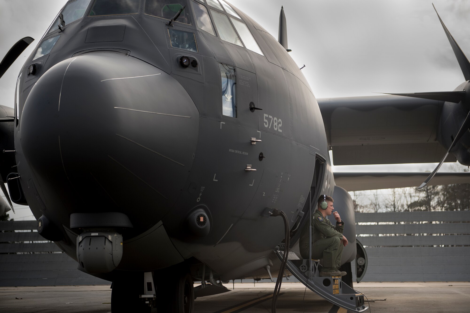 U.S. Air Force Senior Airman Kevin O’Neil, 71st Rescue Squadron loadmaster, waits for engine start-up, Dec. 11, 2015, at the Lockheed Martin C-130 Ramp in Marietta, Ga. The HC-130J, tail number 13-782, is the seventh HC-130J the 71st RQS has received. (U.S. Air Force photo by Senior Airman Ryan Callaghan/Released)