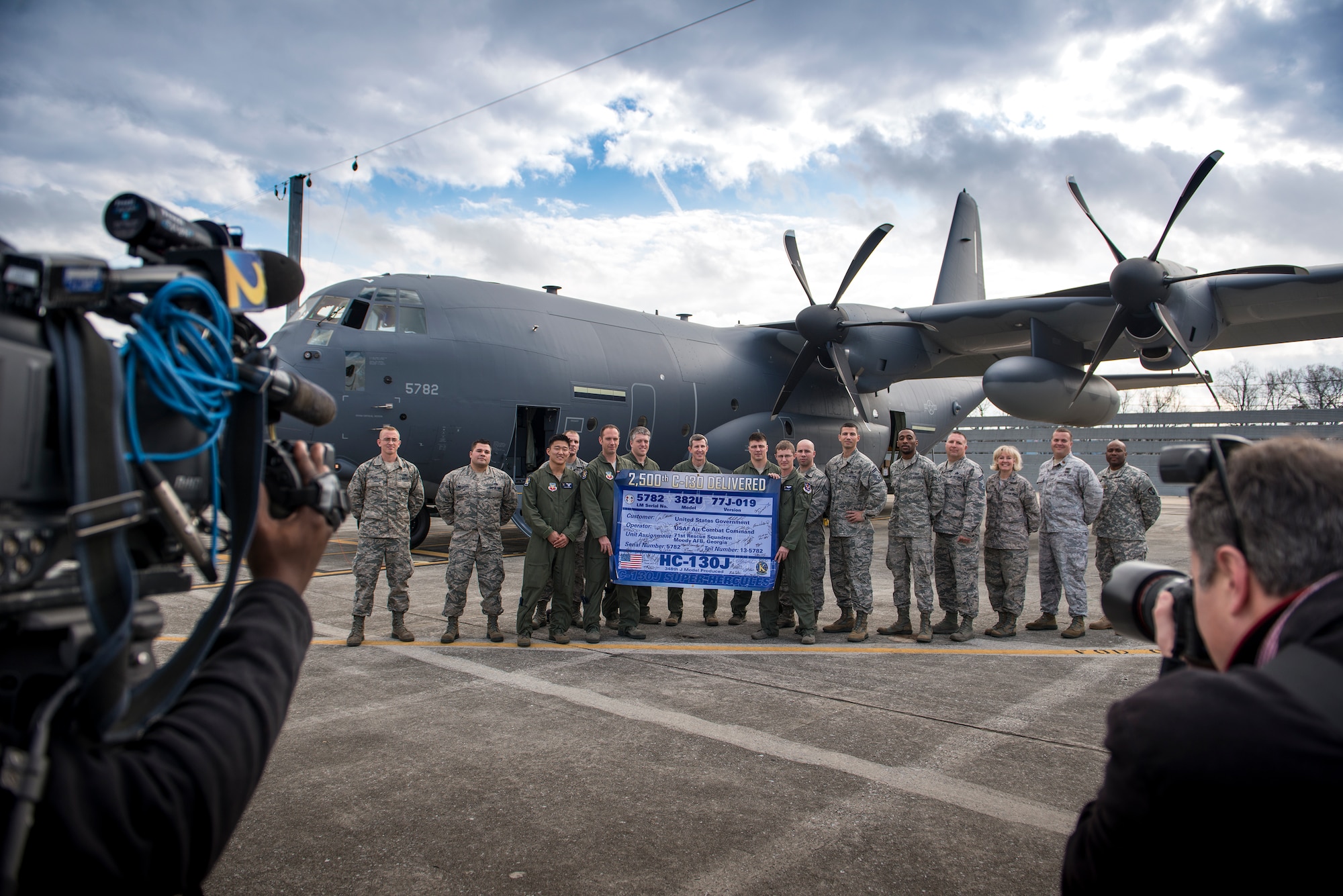 Airmen from the 71st Rescue Squadron, the 71st Aircraft Maintenance Unit and the Defense Contract Management Agency pose for a photo in front of an HC-130J Combat King II, Dec. 11, 2015, at the Lockheed Martin C-130 ramp in Marietta, Ga. The HC-130J, tail number 13-782, is the 2,500th C-130 delivered by Lockheed Martin. (U.S. Air Force photo by Senior Airman Ryan Callaghan/Released)