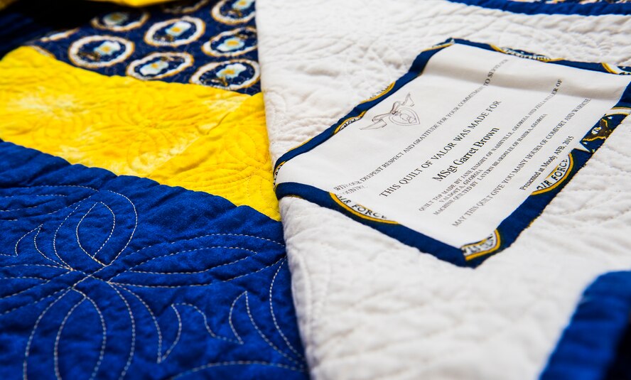 A quilt rests on a table during the Quilts of Valor presentation, Dec. 9, 2015, at Moody Air Force Base, Ga. Members of a local quilting guild made seven quilts for Purple Heart recipients from the 820th Base Defense Group. (U.S. Air Force photo by Senior Airman Ceaira Tinsley/Released)