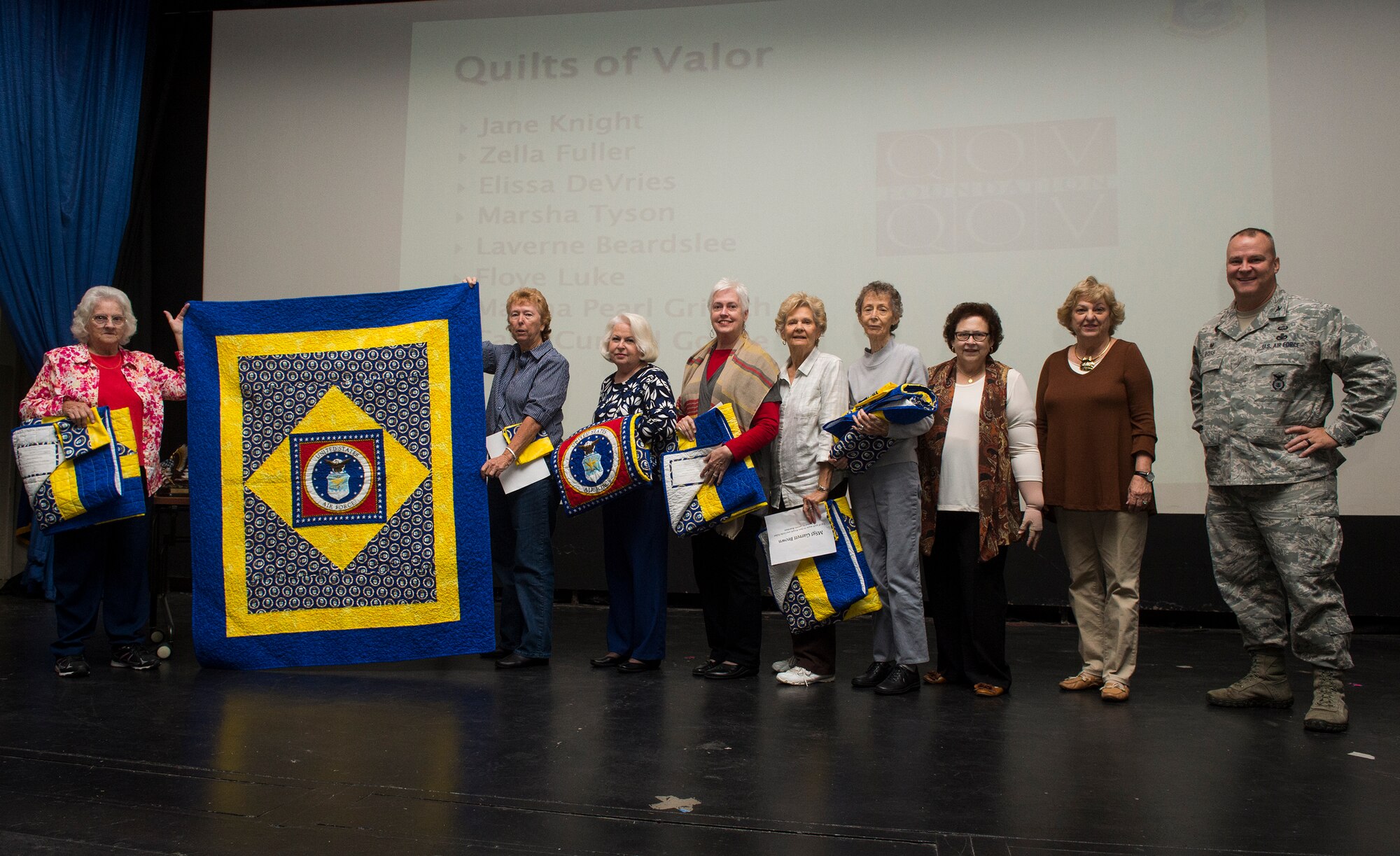 U.S. Air Force Col. Michael Ross, 820th Base Defense Group commander, and members of a local quilting guild pose for a photo during the Quilts of Valor presentation, Dec. 9, 2015, at Moody Air Force Base, Ga. The quilters made seven quilts to award to Airmen from the 820th BDG, two of which were present for the event. (U.S. Air Force photo by Senior Airman Ceaira Tinsley/Released)