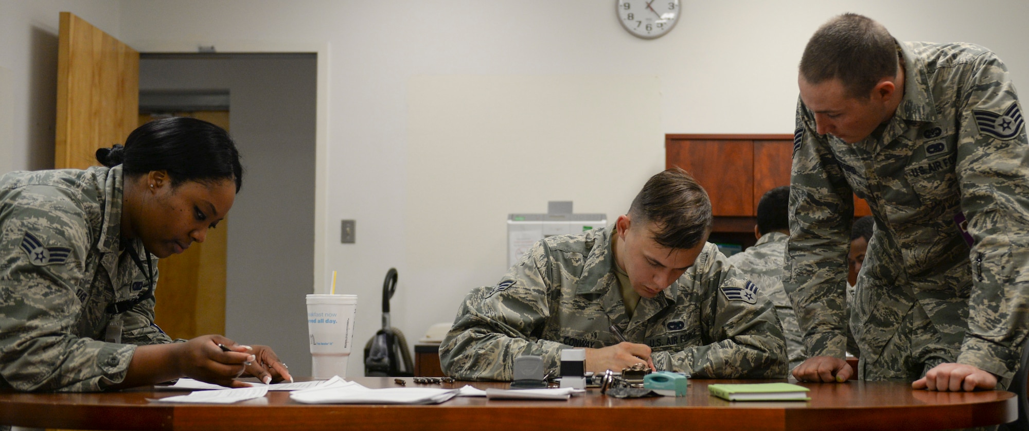 Staff Sgt. Timothy Mefford, a 49th Judge Advocate paralegal, assists Senior Airman Ryan Walker, a 49th administration journeyman, and Senior Airman Austin Conway, a 49th vehicle maintenance journeyman, with a Power of Attorney form during the Legal Hawk Outreach Program visit to the 49th Material Maintenance Support Squadron at Holloman Air Force Base, New Mexico on Dec. 4. The outreach program was created to provide quality legal assistance to those who were having difficulty making it to the legal office. (U.S. Air Force photo by Staff Sgt. E’Lysia A. Wray)