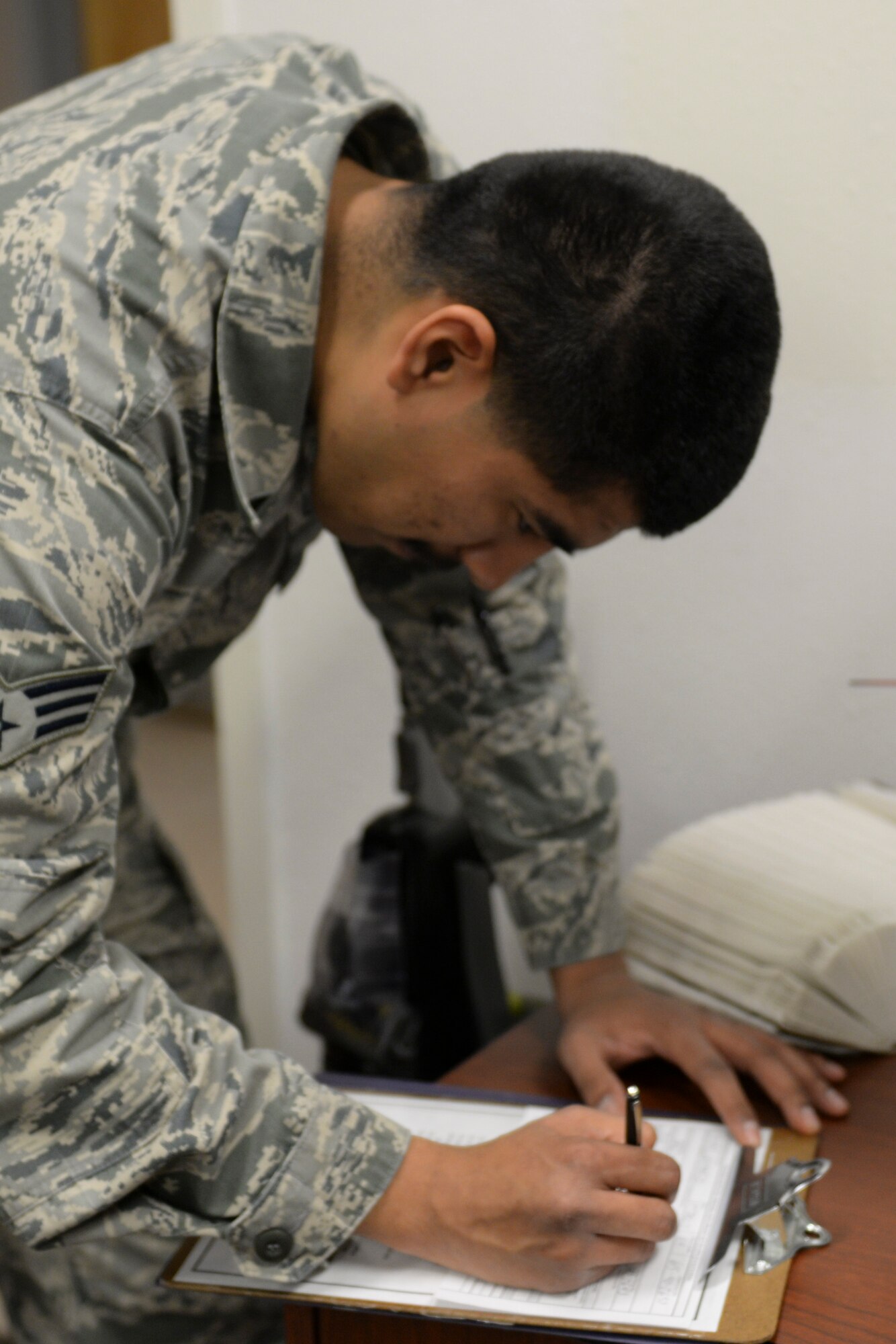 Senior Airman Geovanni Nunez, a 49th vehicle maintenance journeyman, fills out an intake form during the Legal Hawk Outreach Program visit to the 49th Material Maintenance Support Squadron at Holloman Air Force Base, New Mexico on Dec. 4. The outreach program was created to provide quality legal assistance to those who were having difficulty making it to the legal office. (U.S. Air Force photo by Staff Sgt. E’Lysia A. Wray)