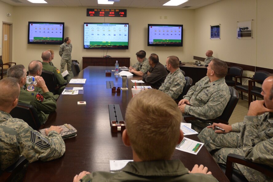 Senior Airman Nadja, 432nd Operations Support Squadron weather ops forecaster, briefs the Wing Commander on the local weather Dec 9, 2015 at Creech Air Force Base, Nevada. Local weather supports the local flying training operations at Creech AFB. They also support any transient aircrews for things like Marine training, Red Flag, Green Flag exercises, and coordinate with Nellis AFB for Nevada Test and Training Range (NTTR). (U.S. Air Force Photo by Senior Airman Adarius Petty)