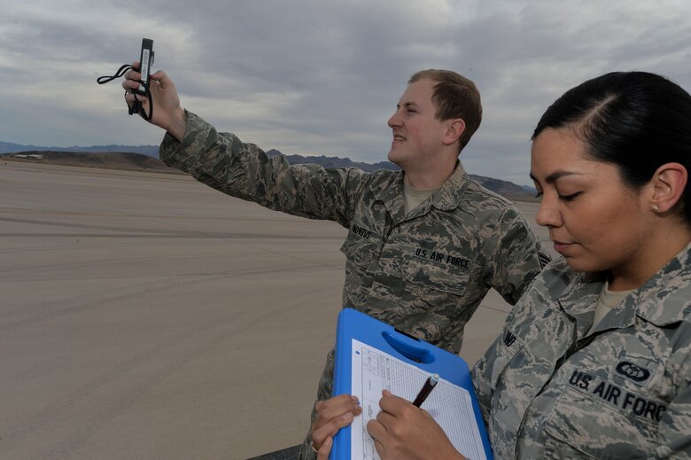 Staff Sgt. Tyler, 432nd Operations Support Squadron RPA weather ops forecaster, and Senior Airman Michelle, 432nd Operations Support Squadron RPA weather ops forecaster, perform a manual observation Dec 9, 2015 on Creech AFB, Nevada. The weather flight is broken up into three sections, 432nd Wing Operations Center weather, 732nd Operations Group weather, and local weather. Each one has its own specific mission. (U.S. Air Force Photo by Senior Airman Adarius Petty)