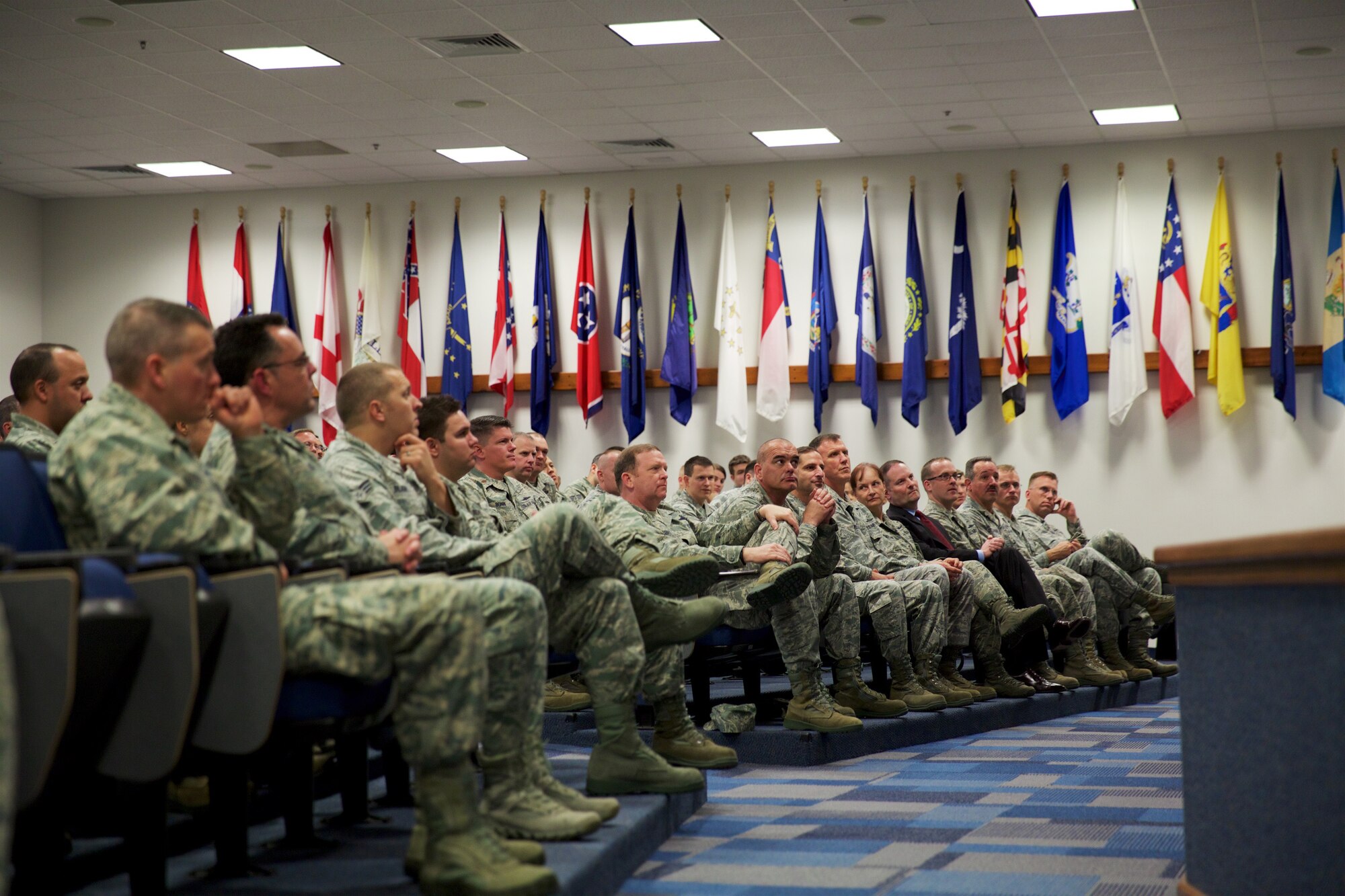 Maj. Gen. Richard Scobee, 10th Air Force commander (center left), and Chief Master Sgt. Thomas Brandhuber, 10th Air Force command chief (center right), listen along with other Citizen Airmen during 960th Cyberspace Operations Group briefings at the Robert D. Gaylor NCO Academy Auditorium Dec. 5. Scobee and Brandhuber visited the Group Dec. 4-6, where they received briefings on the Group’s unique and diverse cyber missions, spent time with the Citizen Airmen who execute those missions, and attended the Group’s annual holiday party. (U.S. Air Force Photo/Tech. Sgt. Miguel Naranjo) 
