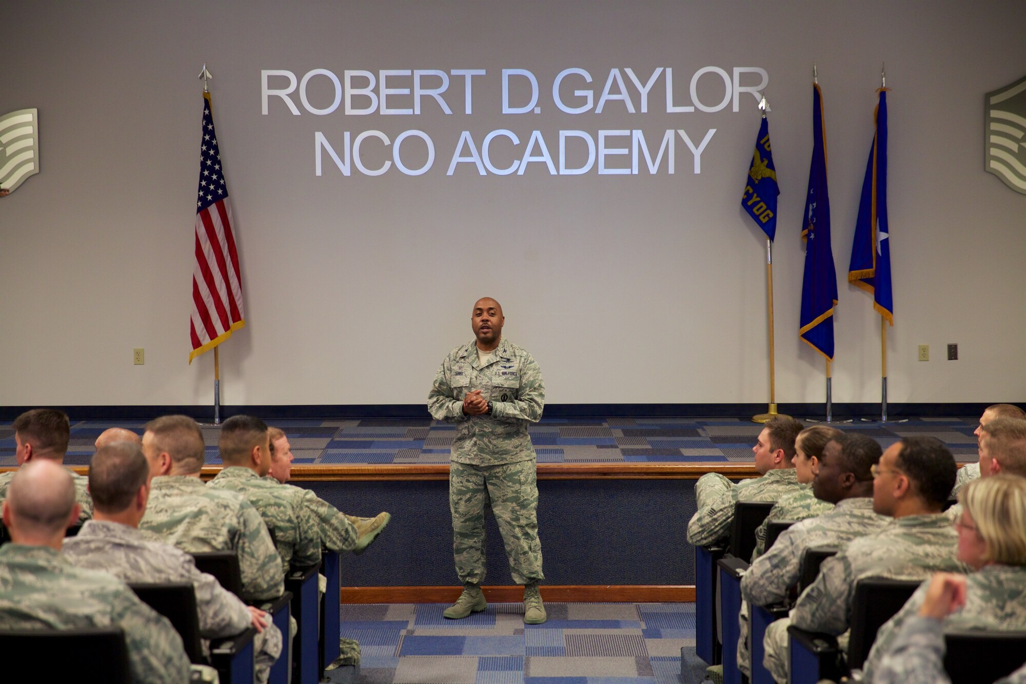 Col. Lloyd Terry, Jr., 960th Cyberspace Operations Group commander, briefs Citizen Airmen during an all call at the Robert D. Gaylor NCO Academy Auditorium, Dec. 5. Terry thanked the group for their hard work in 2015 and spoke about holiday safety before inviting Maj. Gen. Richard Scobee, 10th Air Force commander, to the stage to address the crowd. (U.S. Air Force Photo/Tech. Sgt. Miguel Naranjo)     