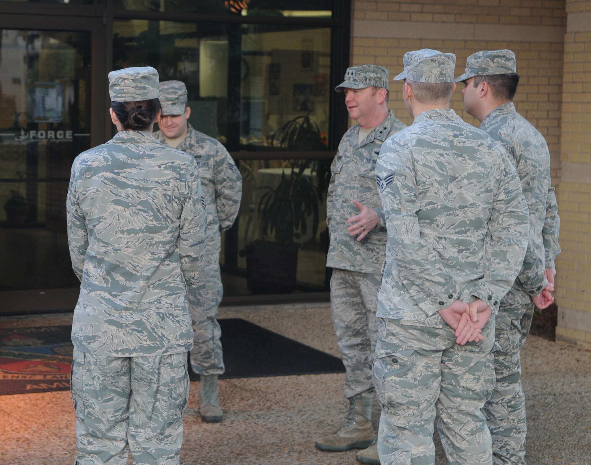 Maj. Gen. Richard Scobee, 10th Air Force commander, speaks with Citizen Airmen assigned to the 960th Cyberspace Operations Group outside the Amigo Inn Dining Facility at Joint Base San Antonio-Lackland, Texas, Dec. 5.  During his visit, the commander was briefed about the Group’s unique and diverse cyber missions, spent time with the personnel who execute those missions, and attended the Group’s annual holiday party. (U.S. Air Force Photo/Senior Airman Cesar Zayas)    