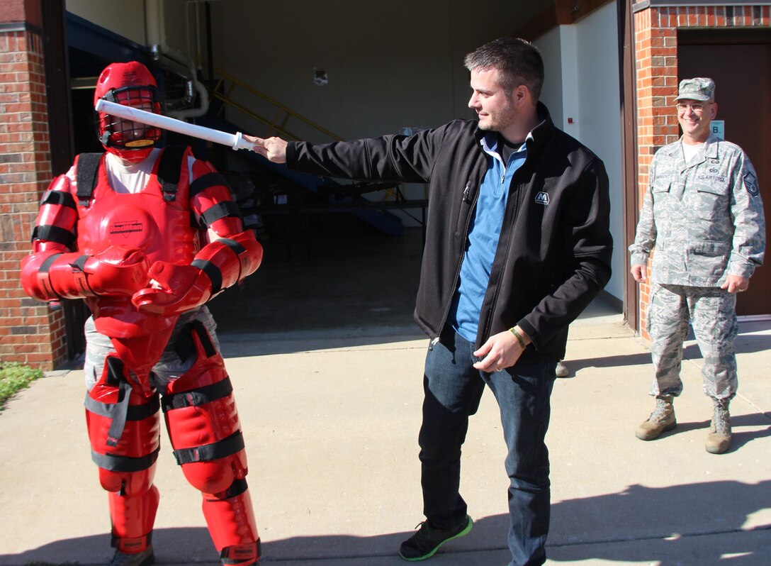 Master Sgt. Gerald Sonnenberg, the wing historian at right, enjoys watching history in the making as Bosses from the Saint Louis region visited the 932nd Airlift Wing, and had a unique chance to take turns hitting the red man security forces hand to hand combat training simulator. The 932nd Airlift Wing public affairs shop produced an informative, detailed and event-packed Boss Day to show off the Illinois unit's military people to civilian employers. It was held during a recent Unit Training Assembly to show many wing activities including an explosive ordnance disposal robot, a medical trauma scenario that 932nd Medical Group members performed for civilian employers, and a look at security forces, all at Boss Day 2015. The commander, Col. Karl Goerke, welcomed the group bright and early that morning. In addition, they saw the Mission Support Group, Operations Group, Maintenance Group and 932nd MDS reservists who conducted a trauma demonstration which highlights the specialized training that Air Force Reserve medical personnel receive. The 932nd Airlift Wing was host to Saint Louis regional civilian employers this year on Scott Air Force Base, Ill. The 932nd AW is the only Air Force Reserve unit that flies the C-40C. (U.S. Air Force photo by Maj. Stan Paregien)