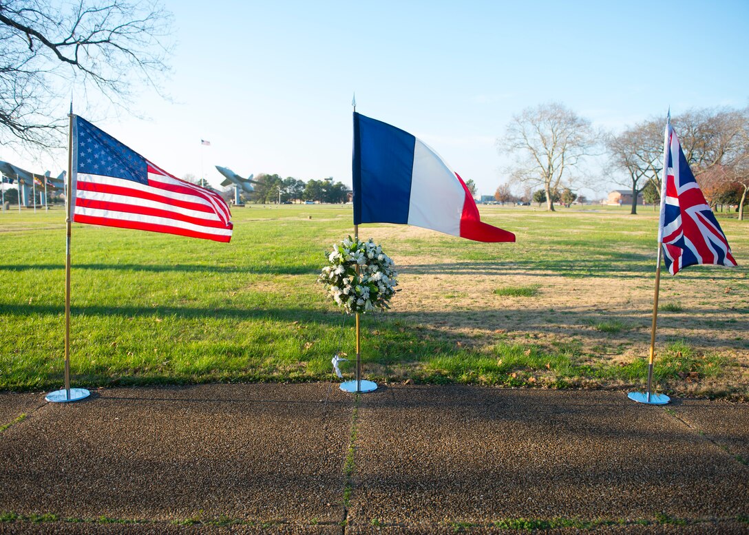 U.S., French and British flags wave together after a wreath laying ceremony at Langley Air Force Base, Va., Dec. 11, 2015. The ceremony was held in remembrance of the victims of recent terrorist attacks in Paris, France. (U.S. Air Force photo by Airman 1st Class Derek Seifert)