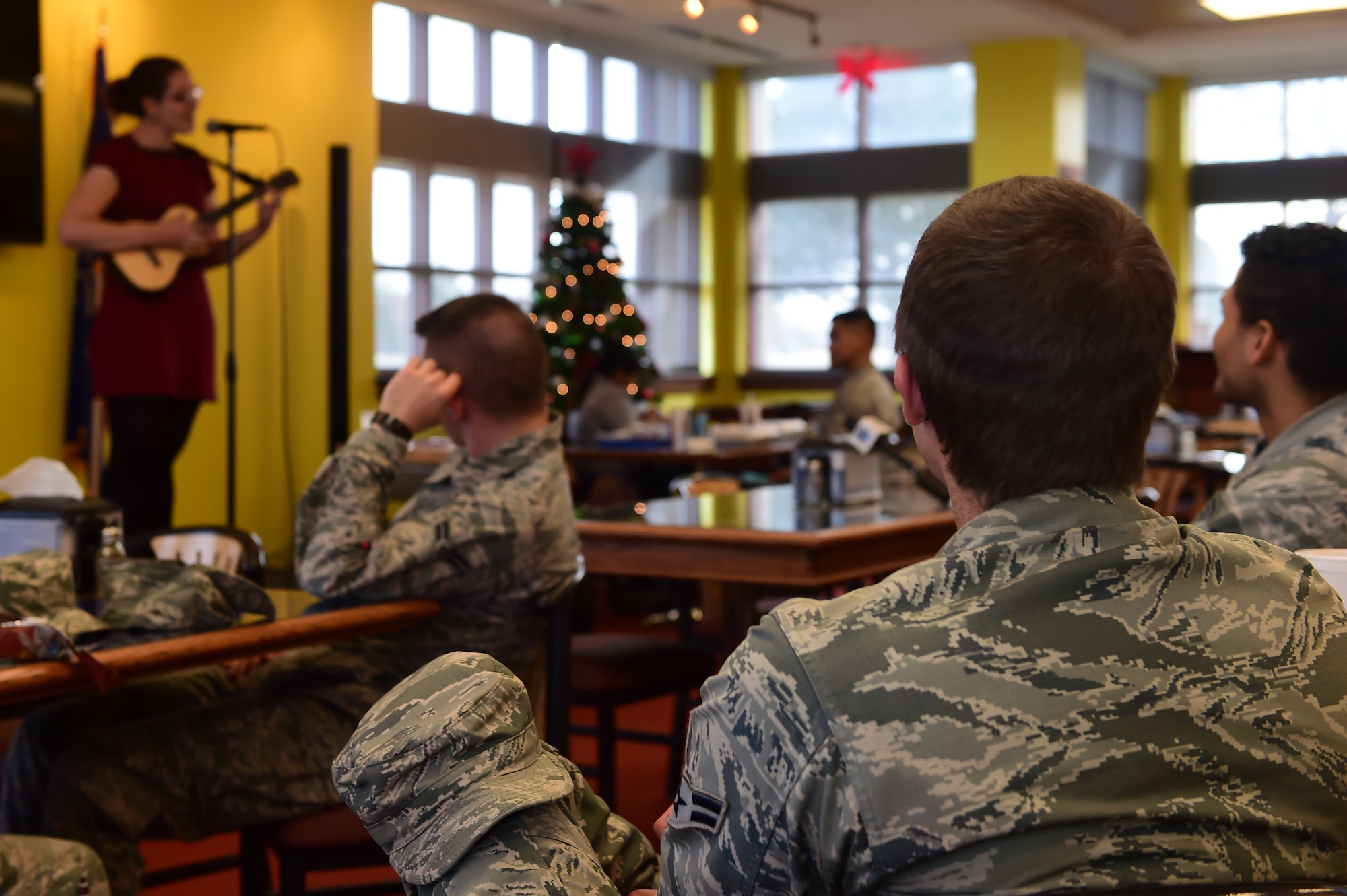 Service members listen to Mandy Harvey, a singer/songwriter, as she performs at the Panther Den Dec. 10, 2015, on Buckley Air Force Base, Colo. Harvey is an accomplished performer who is hearing impaired. She performed at Buckley AFB in honor of National Disability Employment Awareness Month. (U.S. Air Force photo by Airman 1st Class Luke W. Nowakowski/Released)