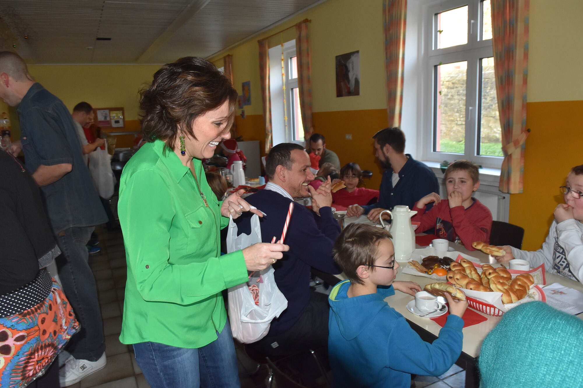 Deb Gates, wife of Chief Master Sgt. Brian Gates, 52nd Fighter Wing command chief, hands out holiday treats at the Bitburg Saint Martin School Dec. 7, during the school’s annual Sankt Nikolaus celebration. The event was attended by school officials, teachers, parents and a delegation from Spangdahlem Air Base consisting of Airmen, spouses and civilians. Earlier in the summer the Saint Martin School children visited the base for Special Children’s Day. (U.S. Air Force photo by Iris Reiff/Released)
