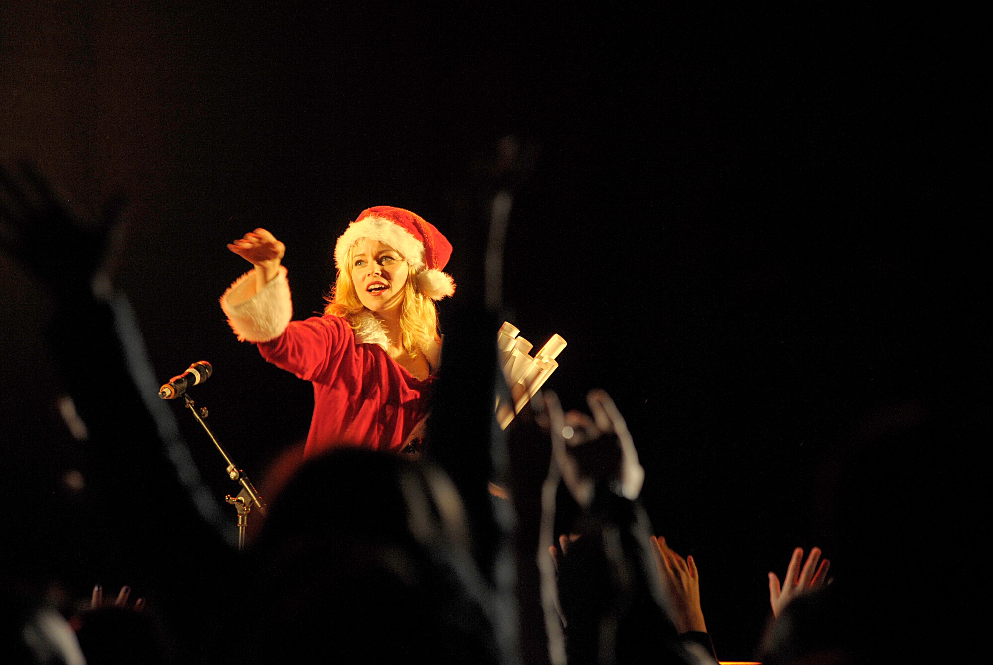 Actress Elizabeth Banks hands out posters during the 2015 USO Holiday Troop Tour Dec. 9, 2015, at Ramstein Air Base, Germany. Banks co-hosted the 15th annual tour, which is designed as a way to show thanks to service members and their families for their service and sacrifices. (U.S. Air Force photo/Staff Sgt. Timothy Moore)