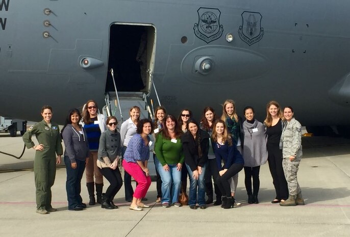 Spouses from the 437th Airlift Wing staff, 14th Airlift Squadron, 15th AS, 16th AS, Aerial Port Squadron and Maintenance Squadron pose for a photo in front of a C-17 Globemaster III during the tour, hosted by Col. John Lamontagne, 437th AW commander, at JB Charleston. S.C. on Dec. 3, 2015. The purpose of the tour was to give spouses a broader perspective of the joint base mission and to say, “Thank you,” for the support they provide to their families every day.