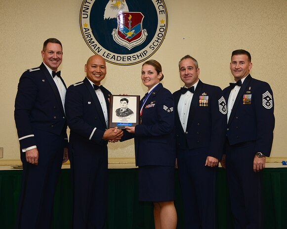 Col. Robert Lyman, Joint Base Charleston commander, Col. Jimmy Canlas, 437th Airlift Wing vice commander, Chief Master Sgt. Kristopher Berg, 437th AW command chief, Chief Master Sgt. Mark Bronson, 628th Air Base Wing command chief, present the John L. Levitow Award to Senior Airman Katherine Stanton, 15th Airlift Squadron instructor loadmaster, Dec. 11, 2015, at Joint Base Charleston – Air Base, S.C. The John L. Levitow award is given for a student’s exemplary demonstration of excellence, both as a leader and a scholar. (U.S. Air Force photo/Tech. Sgt. Rasheen Douglas)