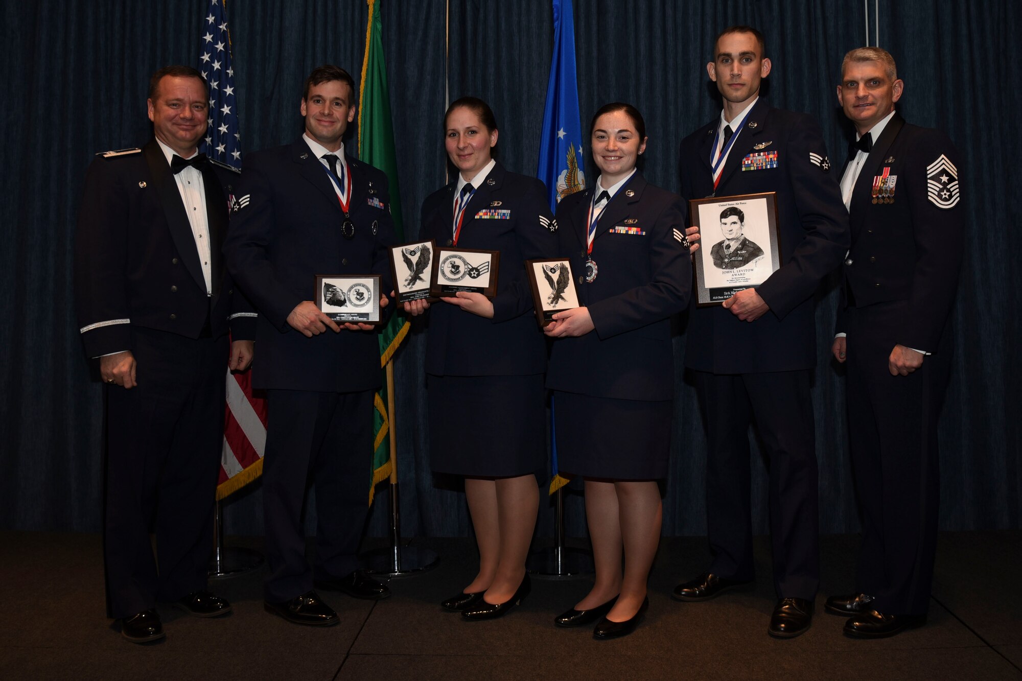 Airmen who earned top honors pose for a photo with Col. Brian McDaniel, 92nd Air Refueling Wing commander, and Chief Master Sgt. Christian Pugh, 92nd ARW command chief, Dec. 10, 2015, at Fairchild Air Force Base, Wash. Airman Leadership School is a five-week course that develops Airmen into supervisors and focuses on leadership abilities, profession of arms and effective communication in the workplace. (U.S. Air Force photo/Airman 1st Class Mackenzie Richardson)