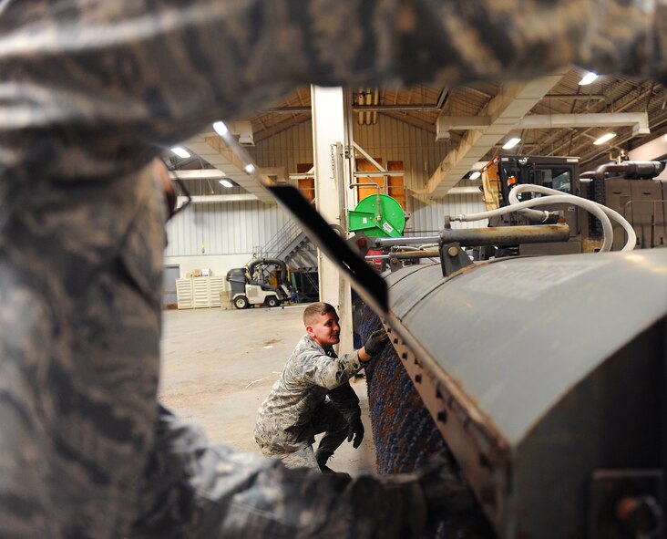 U.S. Air Force Airman 1st Class Joshua Evans, a 509th Civil Engineer Squadron pavements and heavy equipment operator, inspects a snow broom at Whiteman Air Force Base, Mo., Dec. 7, 2015. Members of the pavements and heavy equipment shop inspect all equipment prior to snowfall to ensure everything is fully operational. (U.S. Air Force photo by Airman 1st Class Michaela R. Slanchik)