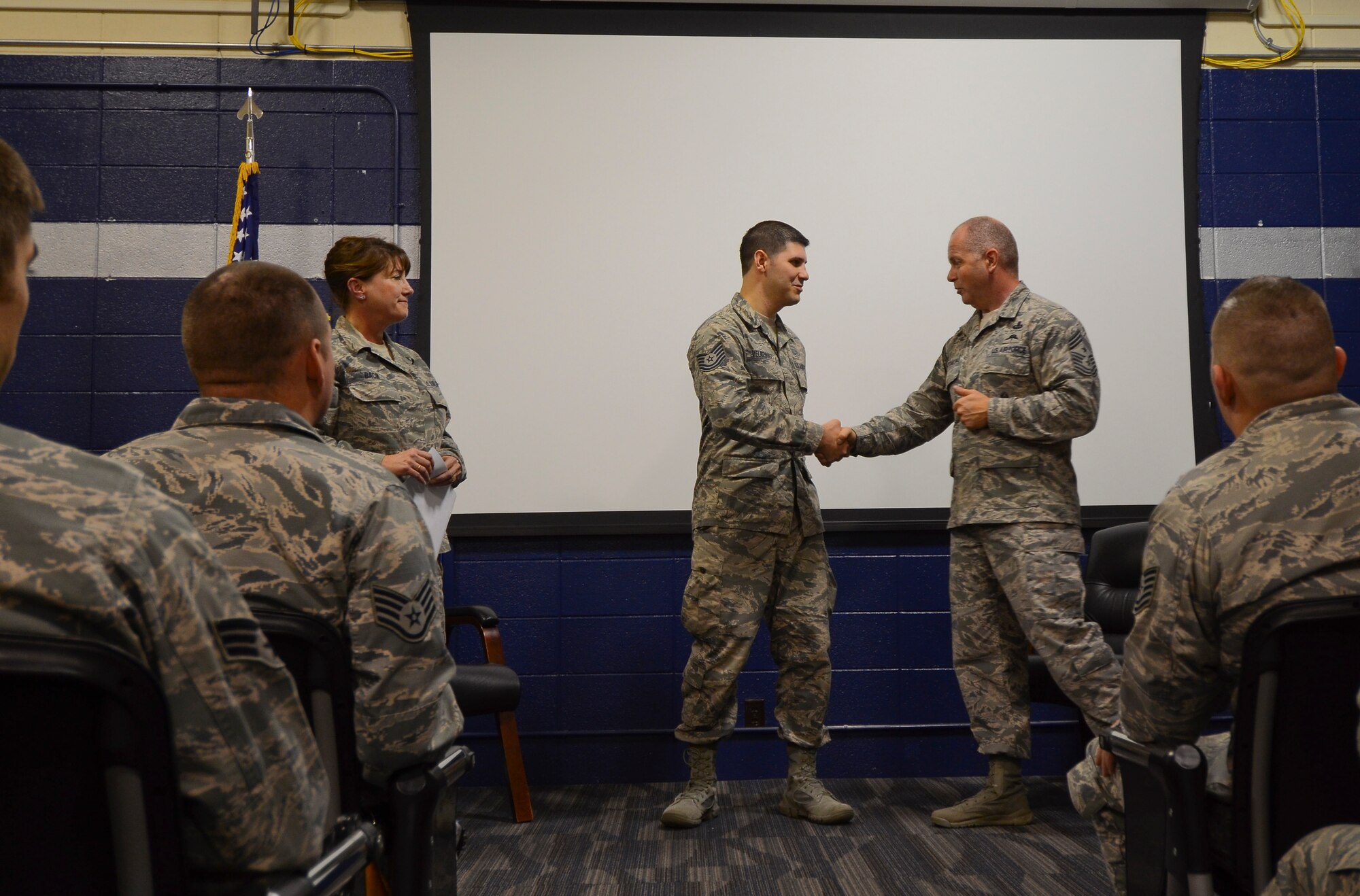 Chief Master Sgt. James W. Hotaling, command chief master sergeant of the Air National Guard, visited the 128th Air Refueling Wing at General Mitchell International Airport Dec. 5, 2015. During the visit Hotaling recognized Tech. Sgt. Eduardo Velazquez, an Airman with the 128th Flight Support Squadron, for outstanding service in personnel readiness and with the base honor guard. (U.S. Air National Guard photo by Tech. Sgt. Meghan Skrepenski/Released)