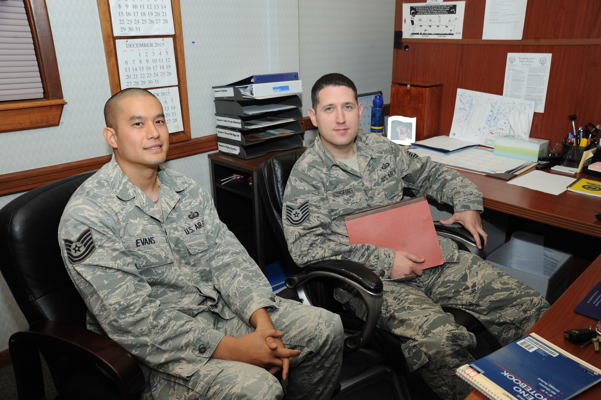 Tech. Sgt. Rungkun Evans, and John Hudgeons, 22nd Air Refueling Wing Director of Staff unit deployment managers, pose for a photo, Nov. 25, 2015, at McConnell Air Force Base, Kan. UDMs manage the deployment process and provide individuals with the necessary knowledge and resources. (U.S. Air Force/Airman Jenna K. Caldwell) 